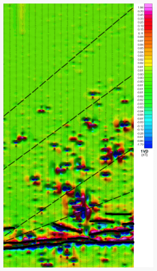 South Block 1VD with interpretation overlaid. The thick black lines represent dykes, or layers, whilst the interpreted structures are shown in dashed line. The numerous small anomalies in the centre of the survey are within a village.