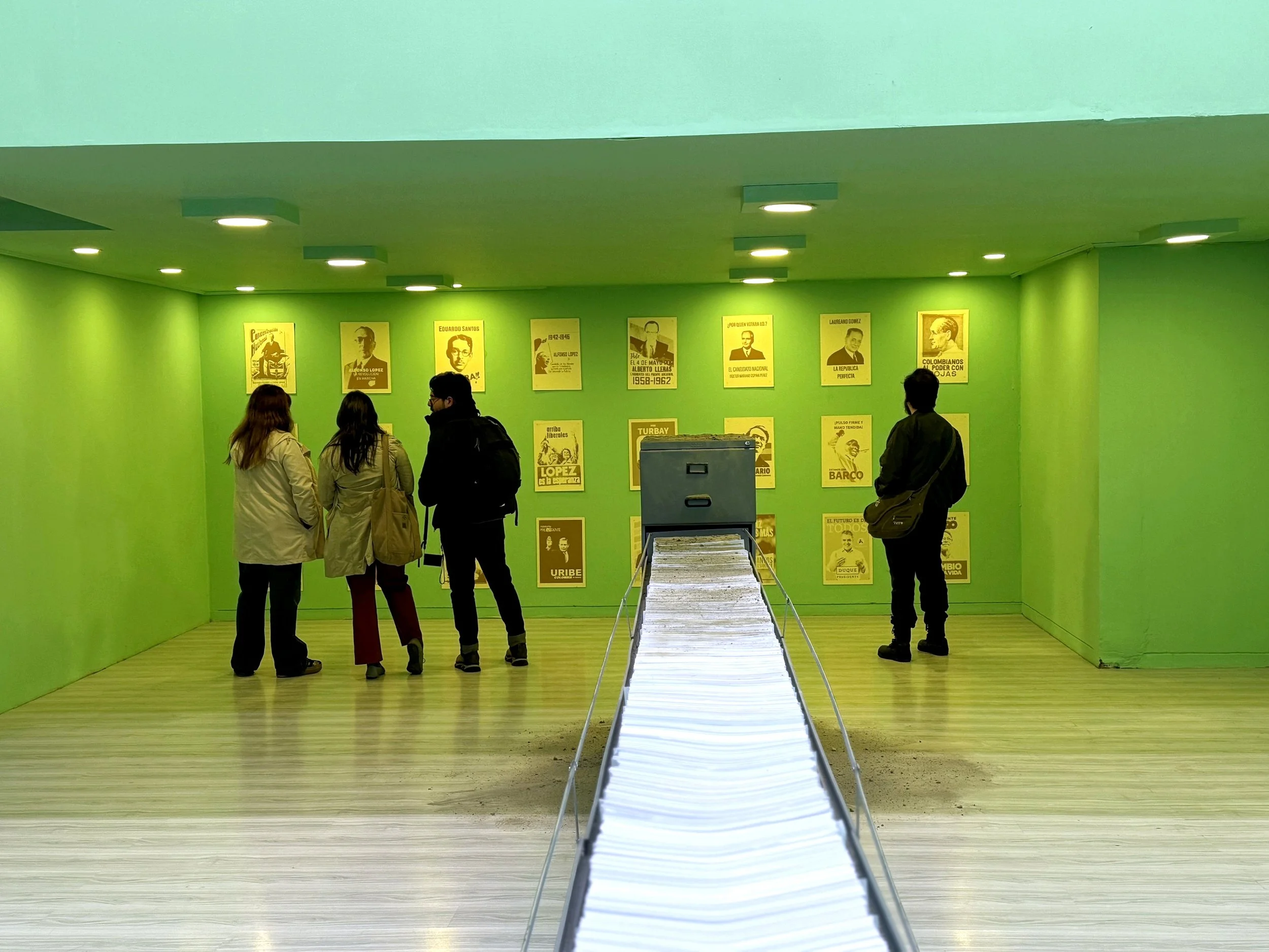 Mordiendo Polvo · Exhibition view with visitors · UN_FAIR, Centro Tequendama · Bogotá, Colombia, 2025