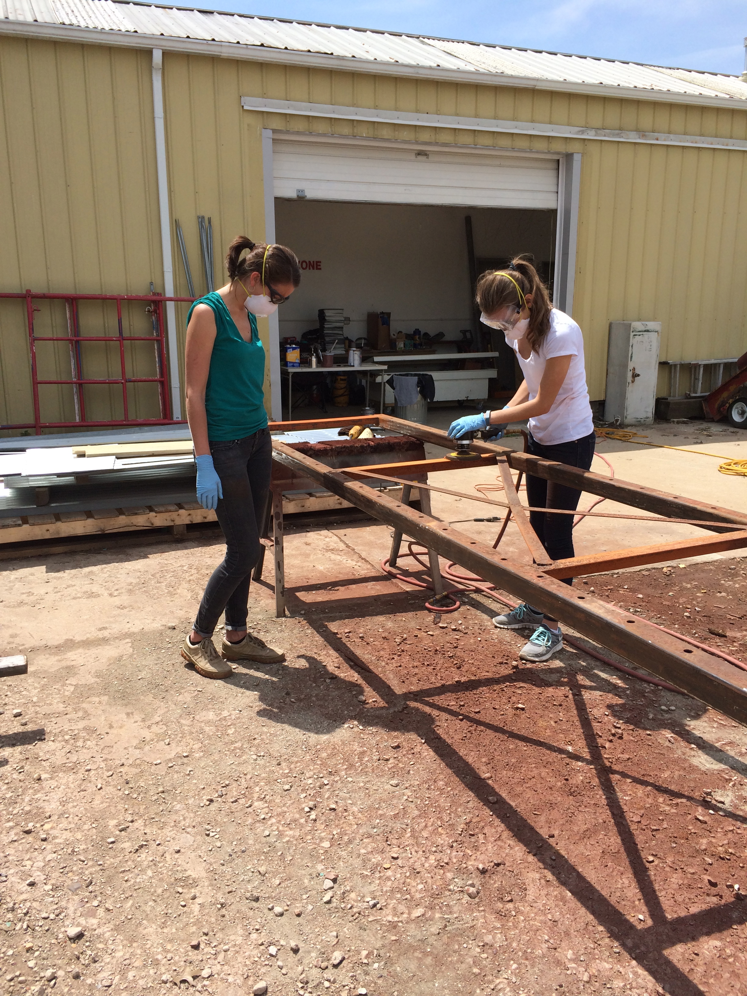 My sister Cerena and I sanding and prepping the structure for the Motorcycle Rack.