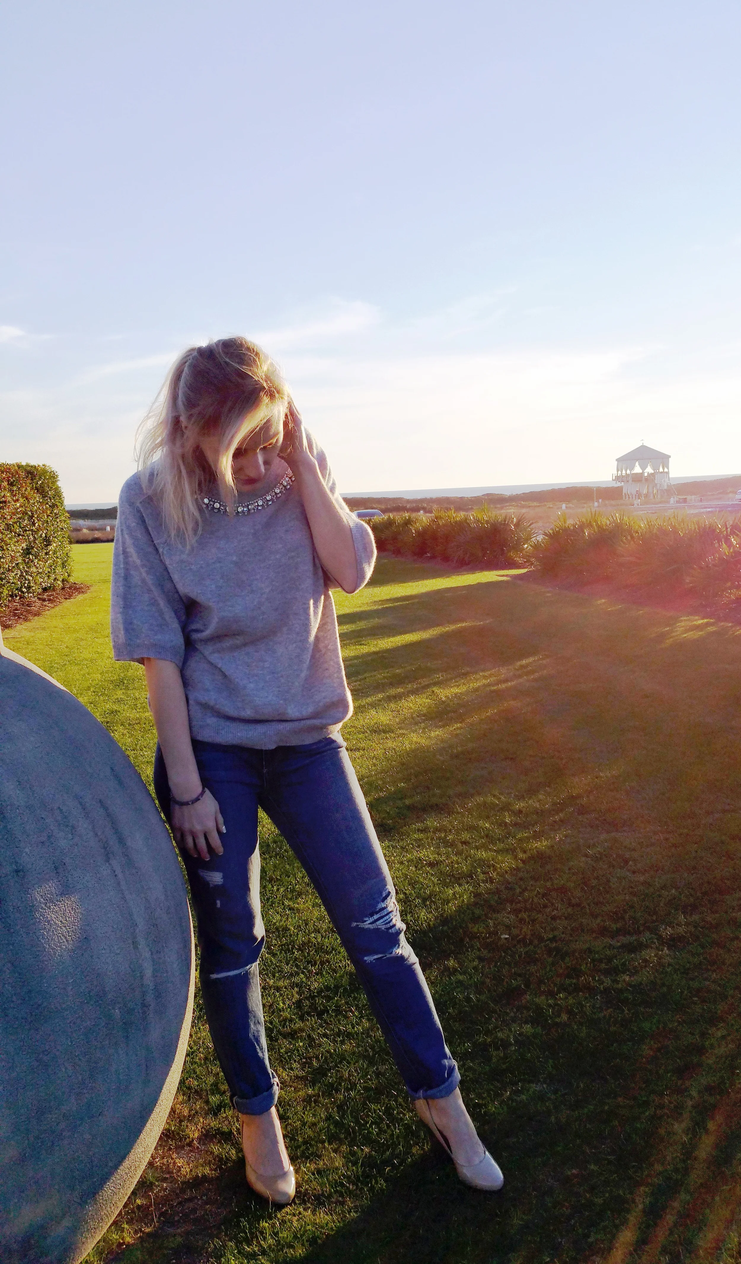 Marta is wearing a jeweled neck gray sweater by Autumn Cashmere, studded bracelet by S Carter & destroyed denim by Paige. 