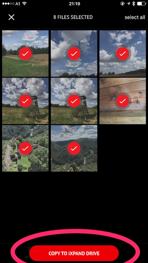 Select photos, tap "Copy to iXpand Drive", select target folder and you're done.