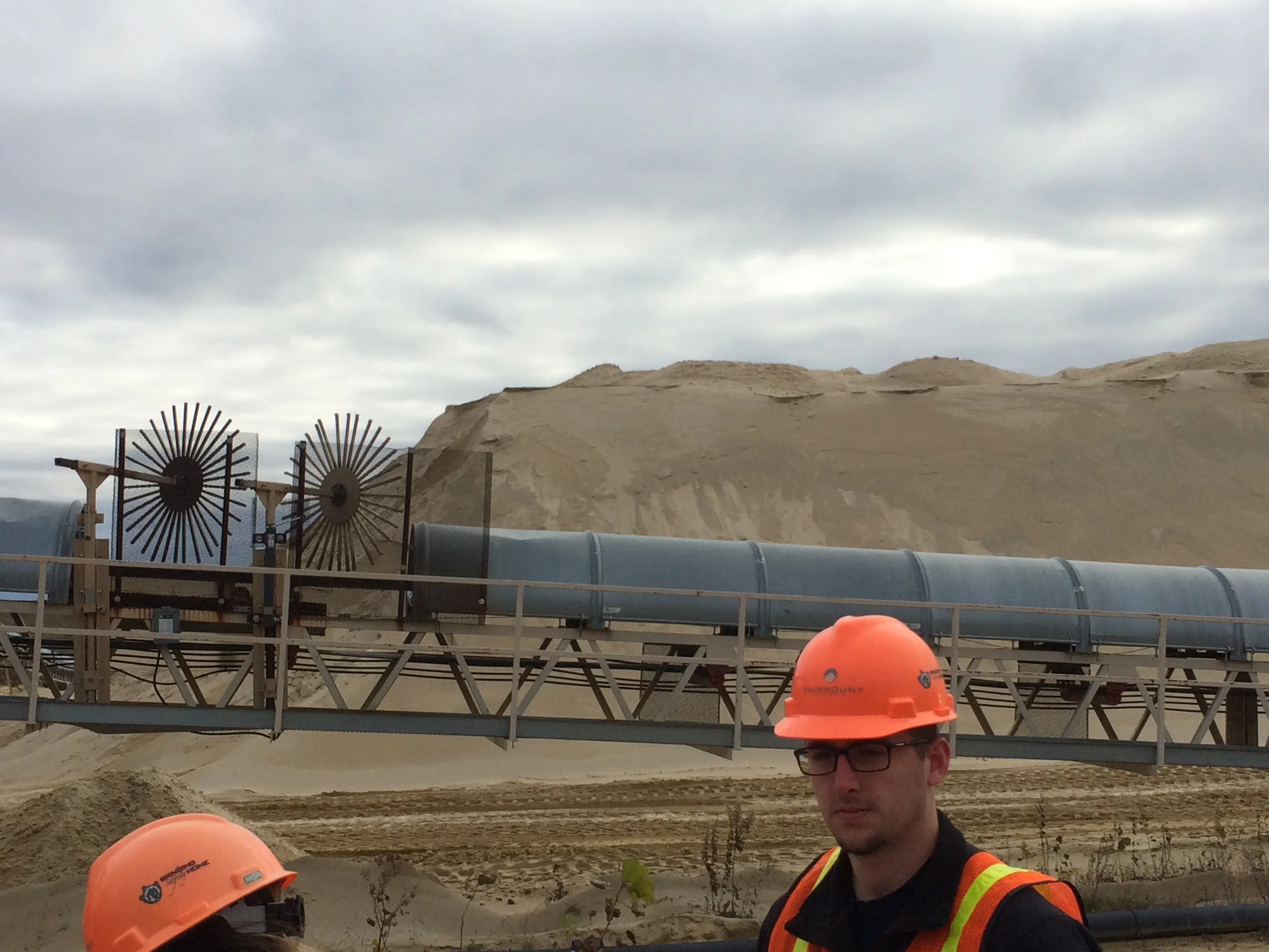 When it's particularly windy, those large circular objects in the left of the picture shoot water onto the pile of sand so it doesn't blow away. Also pictured is Tyler Aken of Pod 8