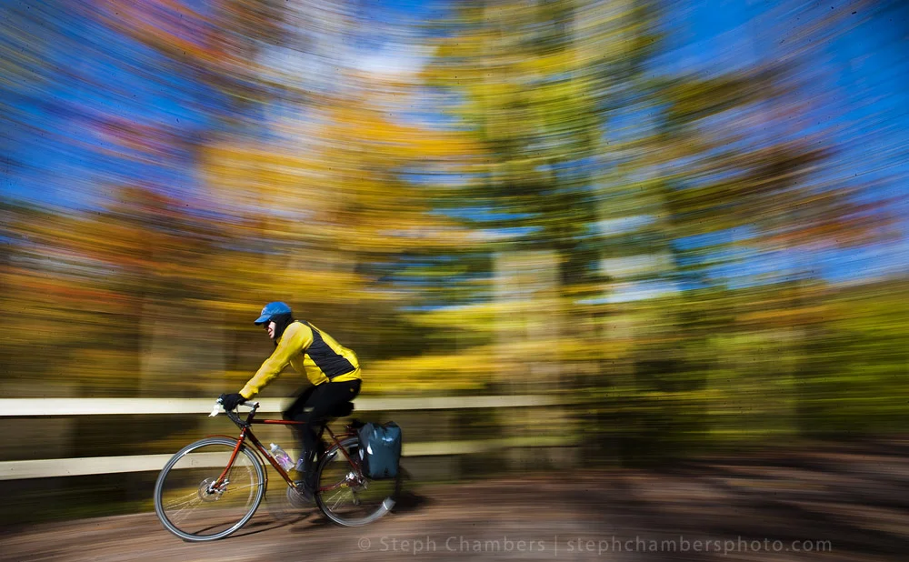 A biker rides along the Great Allegheny Passage past fall foliage in Ohiopyle State Park on Sunday, Oct. 18, 2015.