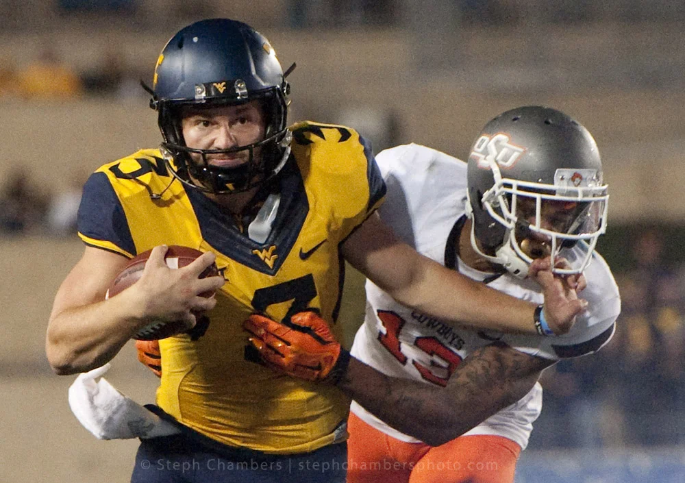 West Virginia quarterback Skyler Howard (3) rushes past Oklahoma State safety Jordan Sterns (13) on Saturday, Oct. 10, 2015 at Milan Puskar Stadium in Morgantown, W.Va. Oklahoma State won 33-26 in overtime.
