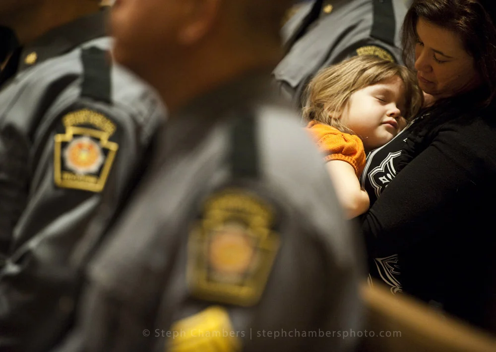 Maren Newcaster, 4, of Jeannette sleeps on her mother Amber as the choir sings "Be Still My Soul" during the third Diocese of Greensburg's First Responders Prayer Service at Blessed Sacrament Cathedral on Thursday, Oct. 22, 2015. Newcaster is the da…