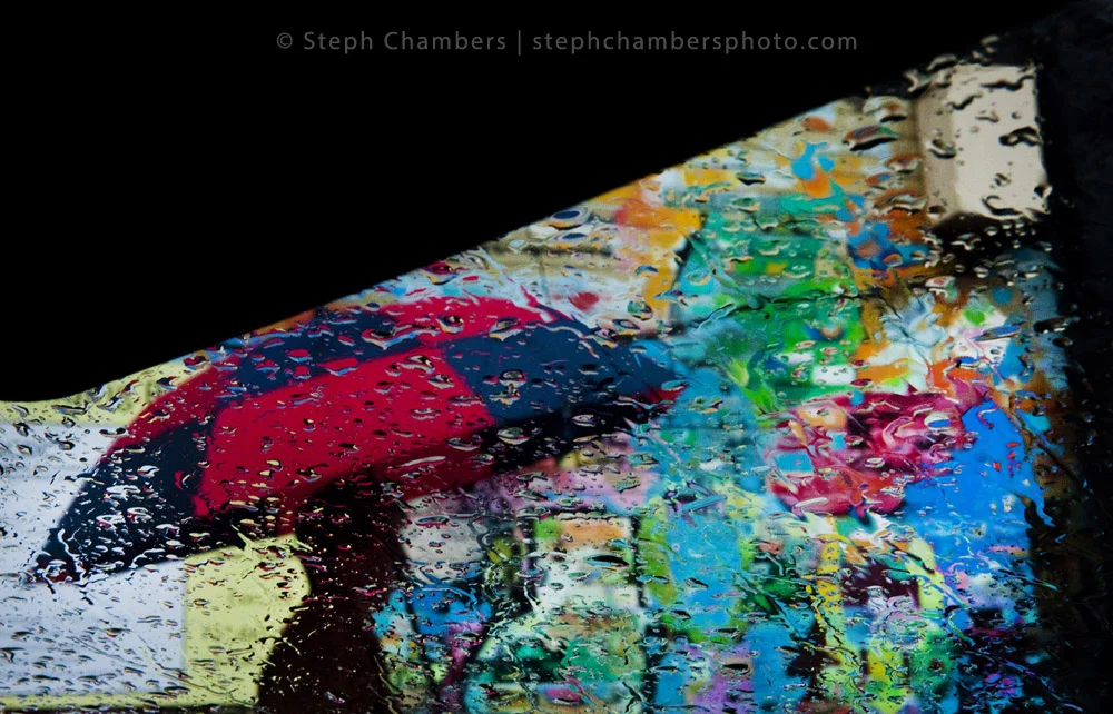 A pedestrian blends into a wall along Pennsylvania Avenue in Greensburg during a rain shower on Oct. 28, 2015.