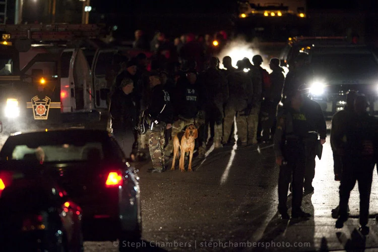 Police search for a suspect in connection with an officer shooting on Saturday, Nov. 28, 2015 in Seward.