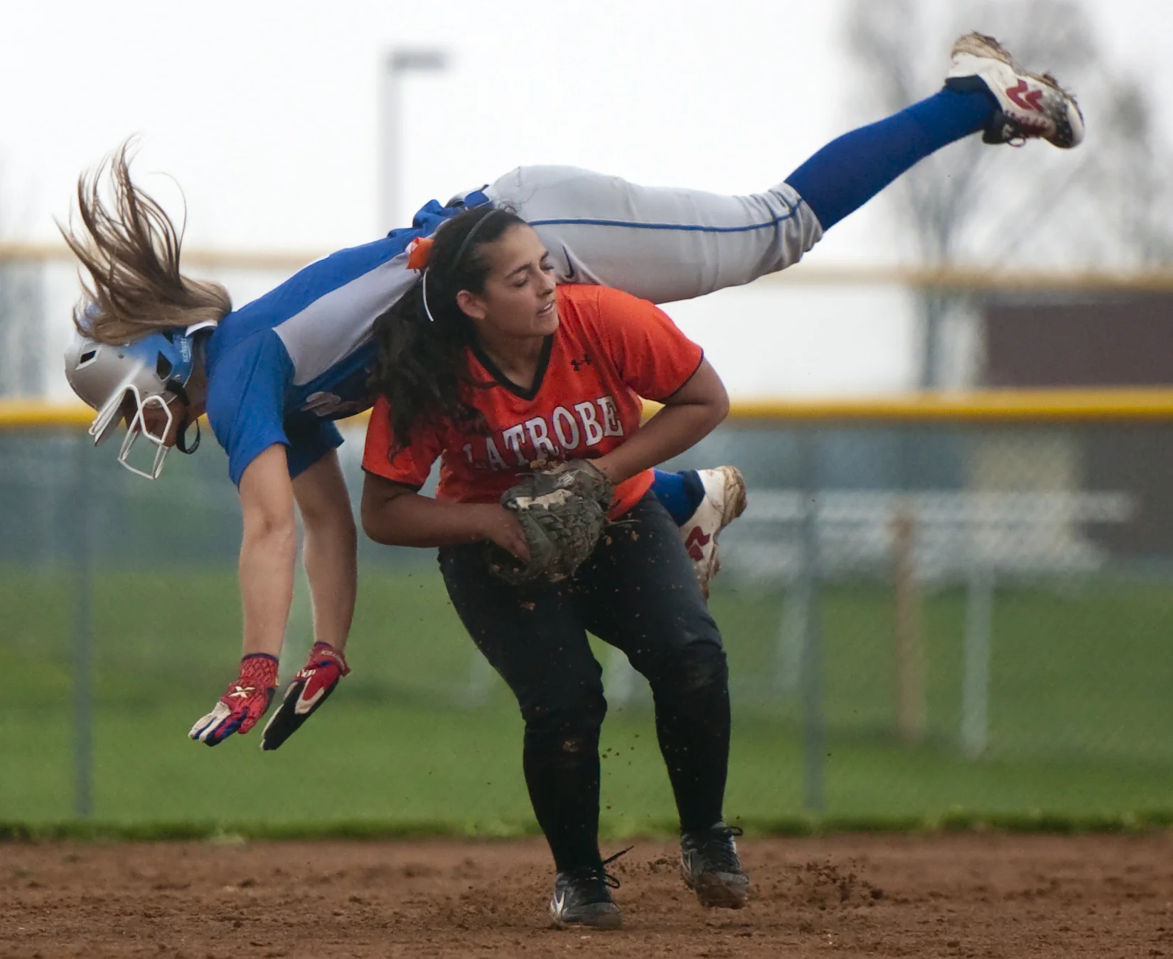 Taylor Hoffman collides with Latrobe's Karley Kovatch during a softball game at Hempfield on Friday, April 22, 2016. Hempfield won 7-1.