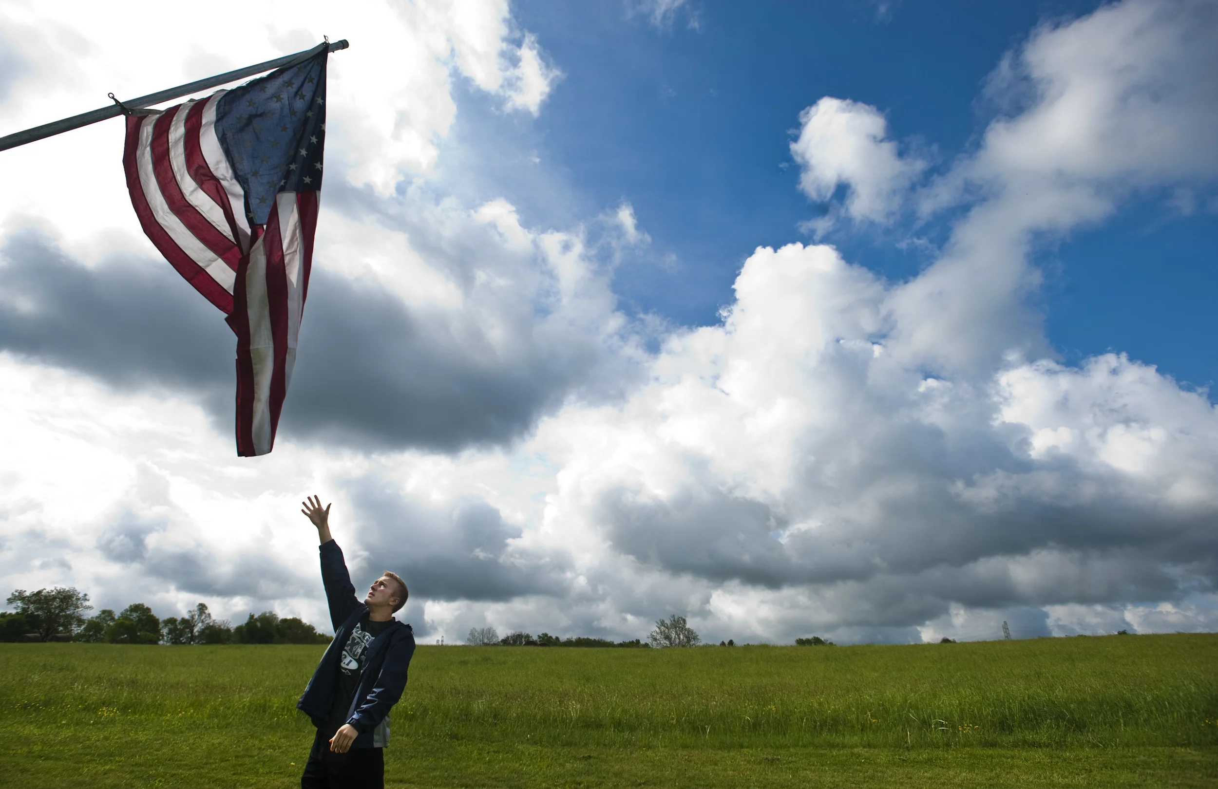 Yough High School senior Jason Walko assists in raising one of 353 American flags with about 40 other Yough students, members of the West Newton VFW Post 7812 and members of West Newton Moose Lodge 31 on Friday, May 13, 2016 at the West Newton Cemetery. In its 22nd year, the Avenue of Flags will honor 353 deceased veterans with flags, which will fly until June 4. Each flag is given by a family member in honor of a local veteran who has passed away. 