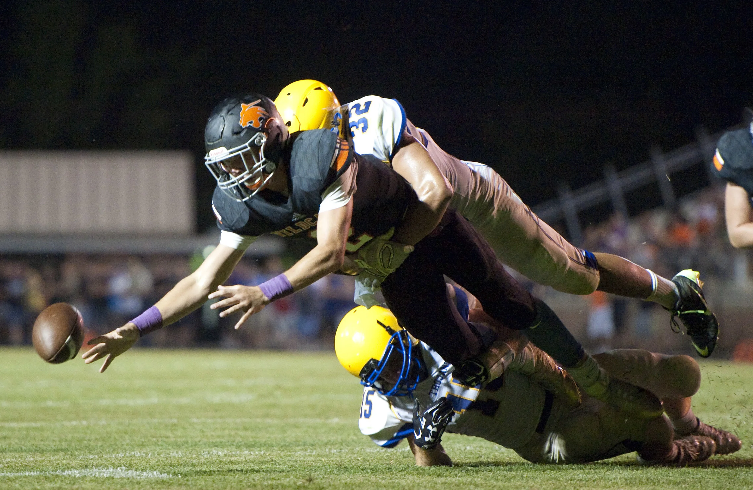Latrobe’s Austin Butler fumbles the ball while hit by Derry’s Noah Wiencek during a football game on Friday, Aug. 26, 2016 Latrobe's Memorial Stadium. Derry won 28-20.