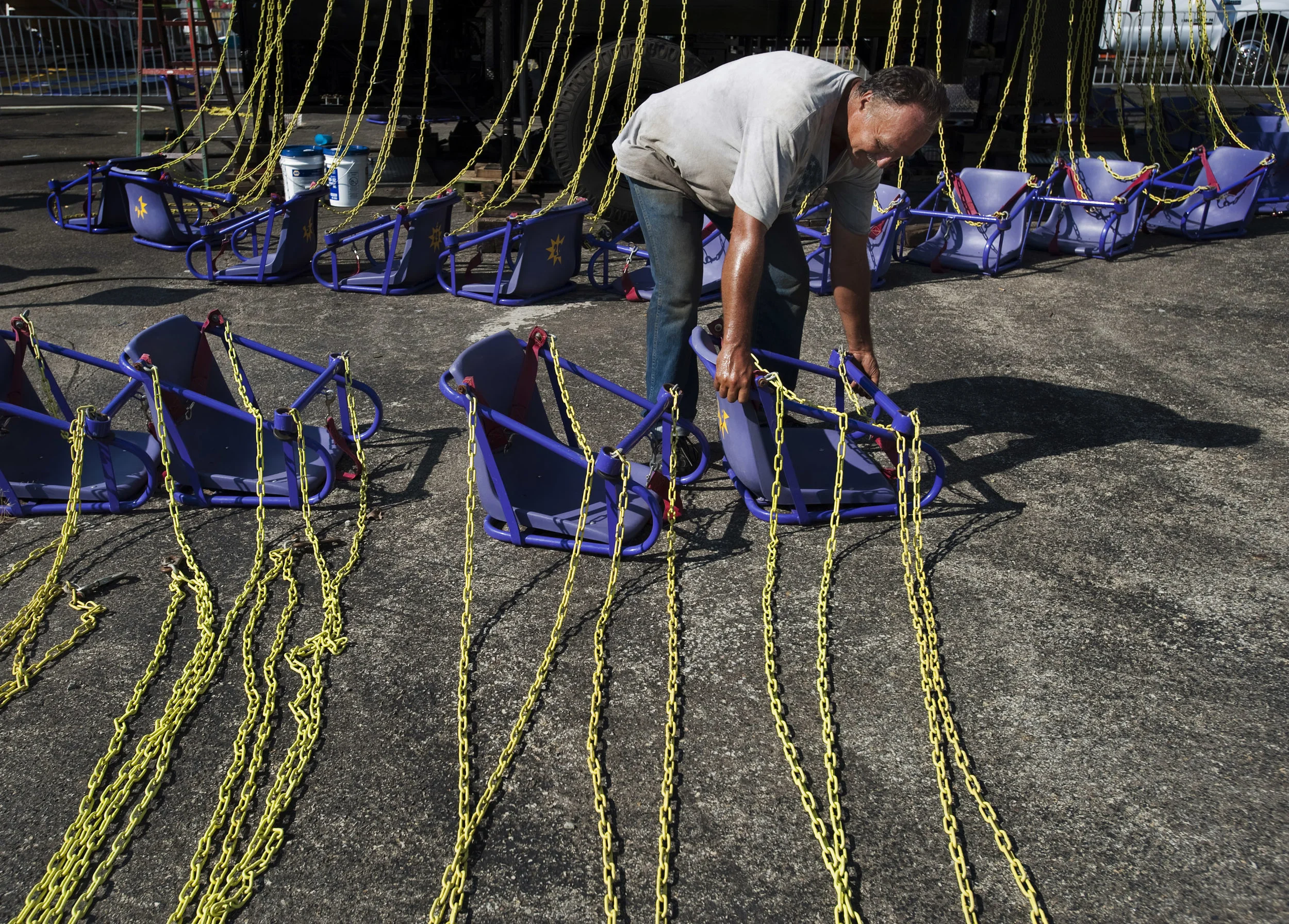 Robert Moem of Scottdale hangs swings to the Yo-Yo ride on Thursday, Aug. 18, 2016 in preparation for the first day of the Westmoreland Fair in Mt. Pleasant Twp, which runs from Aug. 19 through Aug. 27.