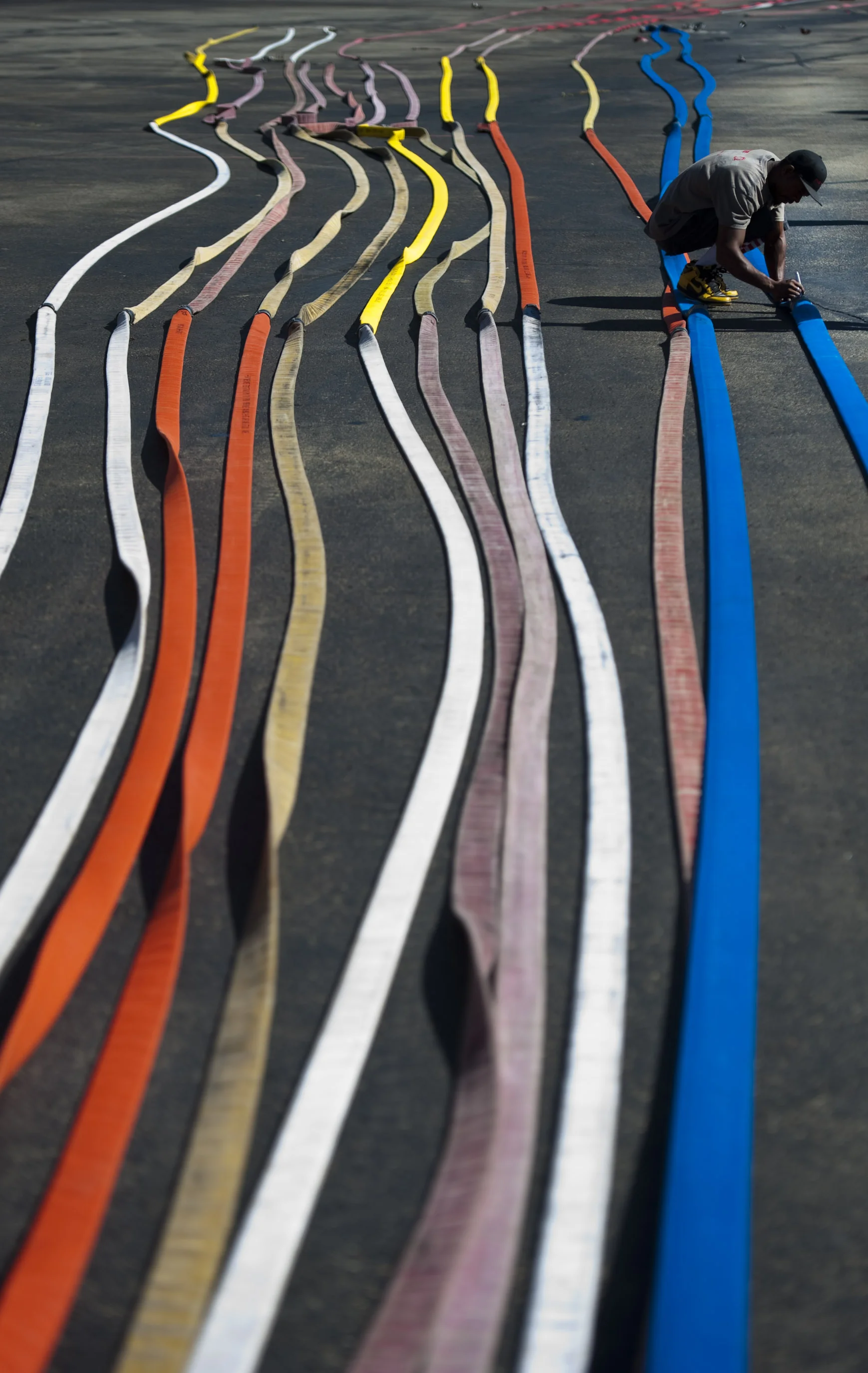 James Coverbale of Fireflow Inc., based in Manahawkin, N.J., tests 80,000 feet of fire hose from the 12 Hempfield Township fire departments on Tuesday, Sept. 27, 2016 in the Z and M Cycle Sales parking lot. Fireflow services the Tri-State area of Ne…