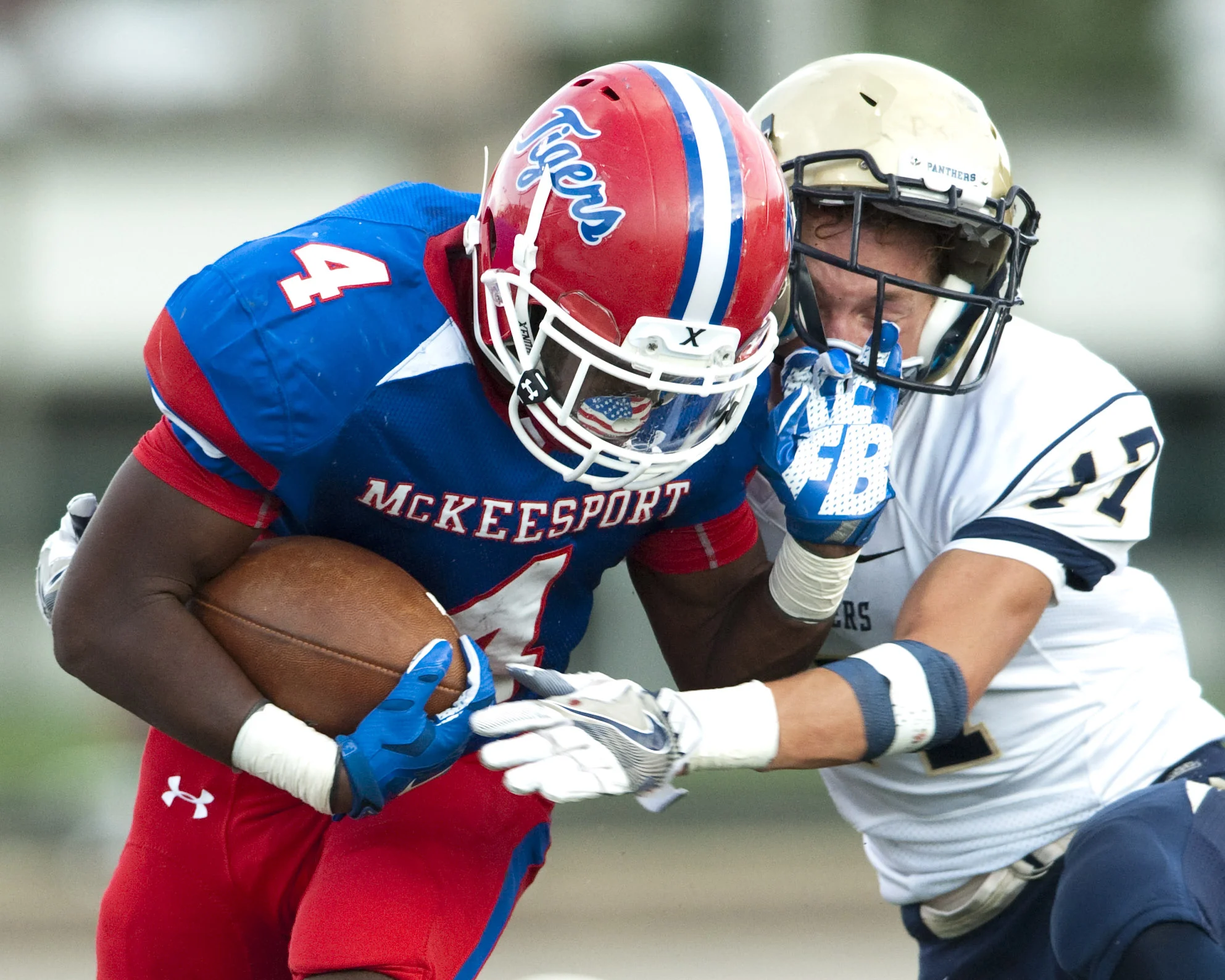 McKeesport’s Breon Green stiff arms Franklin Regional’s Vinny Pysnik on Friday, Sept. 2, 2016 in McKeesport.