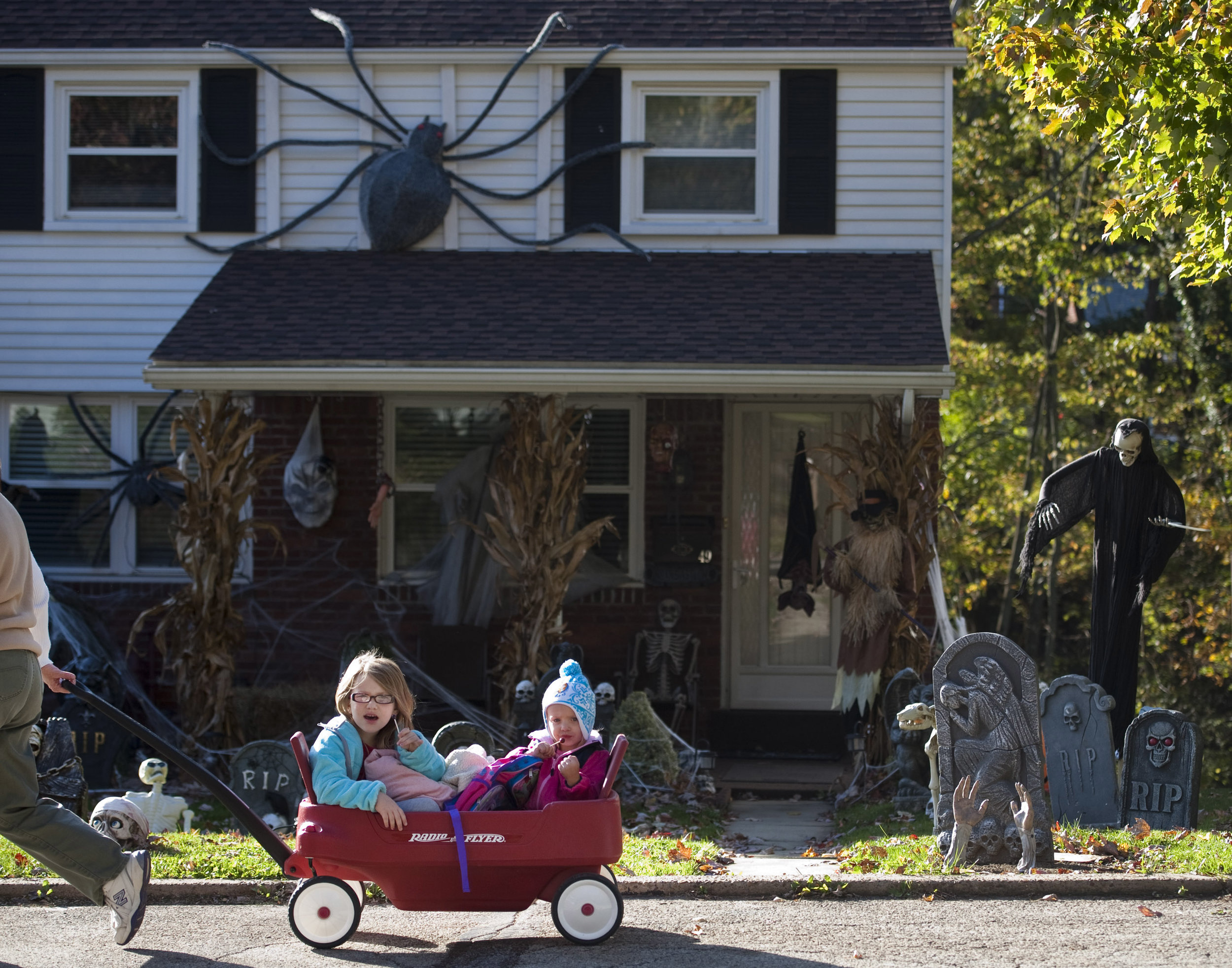  Sisters Carissa and Abby Kelly, 5 and 2, enjoy their lollipops while admiring their neighborhood's Halloween decorations during a walk with their grandmother Linda Kelly along Forest Avenue in Greensburg on Tuesday, Oct. 25, 2016. Carissa and Abby p