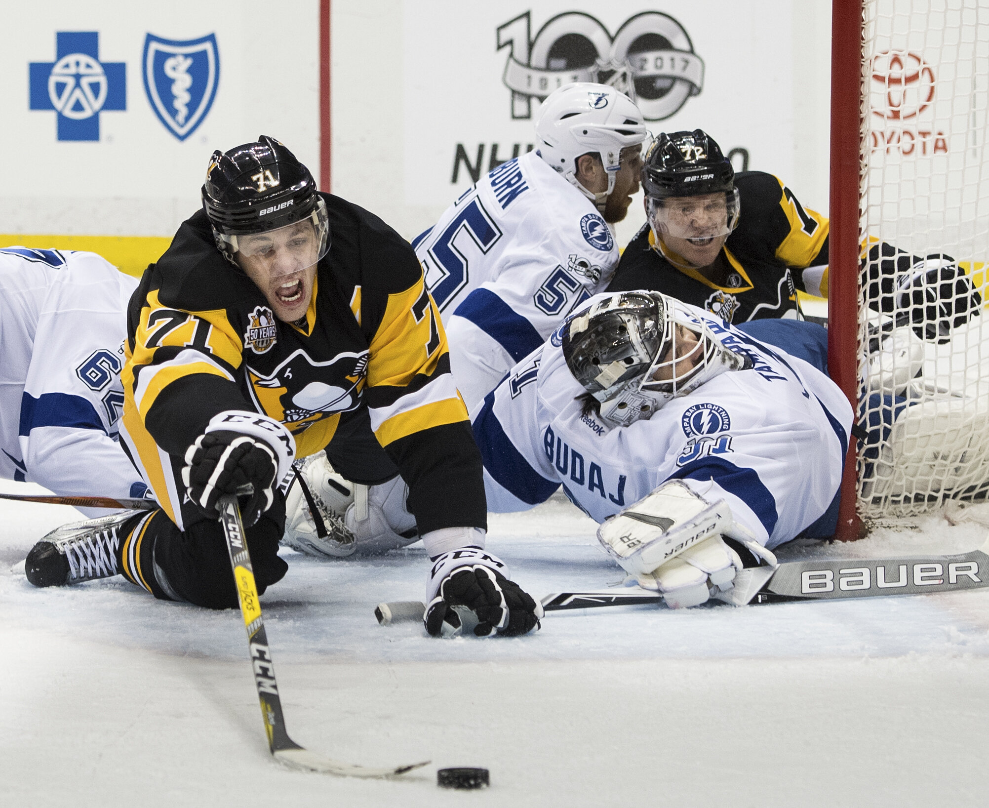  Pittsburgh Penguins center Evgeni Malkin (71) reaches for the puck against Tampa Bay Lightning goalie Peter Budaj (31) in the first period during an NHL game between the Pittsburgh Penguins and the Tampa Bay Lightning at PPG Paints Arena in Pittsbur