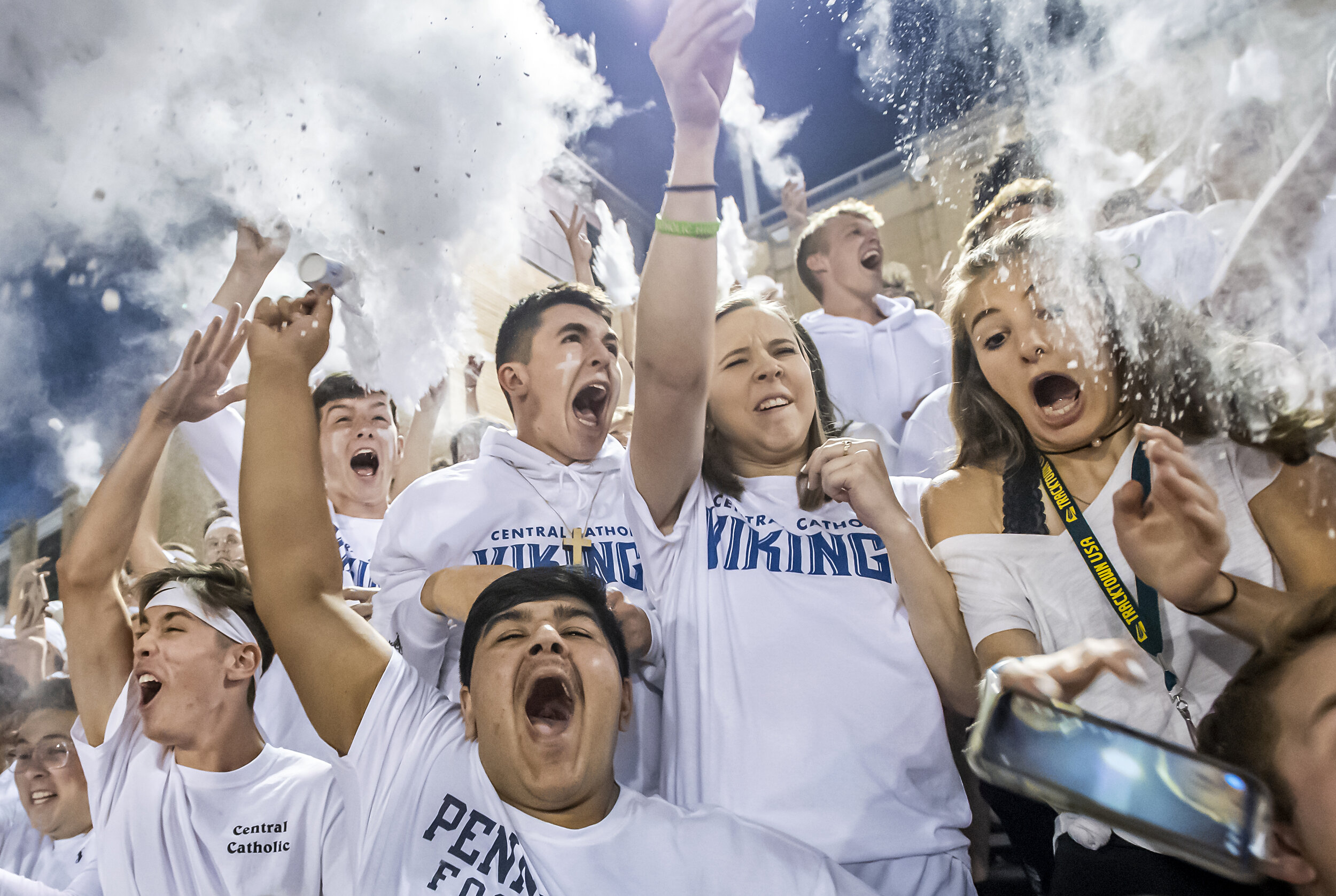 The Central Catholic student section throws baby powder in the air as a girl drops her phone during the opening kickoff against Pine-Richland on Friday, Sept. 27, 2019, at Carnegie Mellon University. Central Catholic beat Pine-Richland, 29-7. 