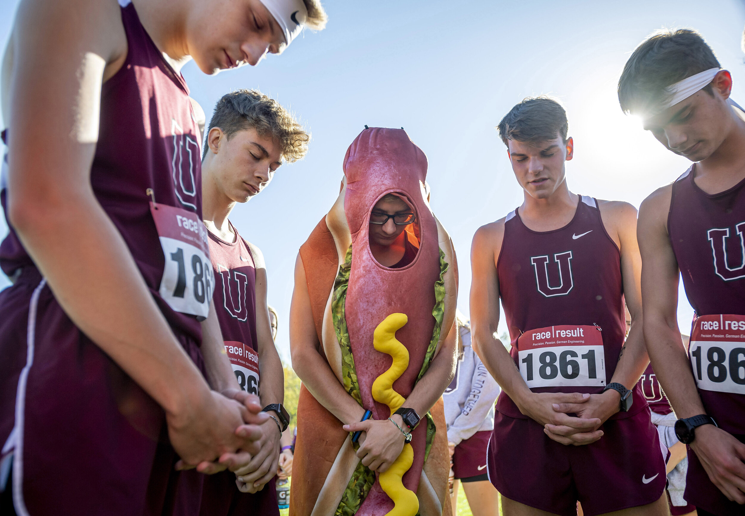  Uniontown's Andrew Maher, dressed as a hot dog, prays with his teammates before the WPIAL boys AA cross country championship Thursday, October 24, 2019, at Roadman Park in California, Pa. 