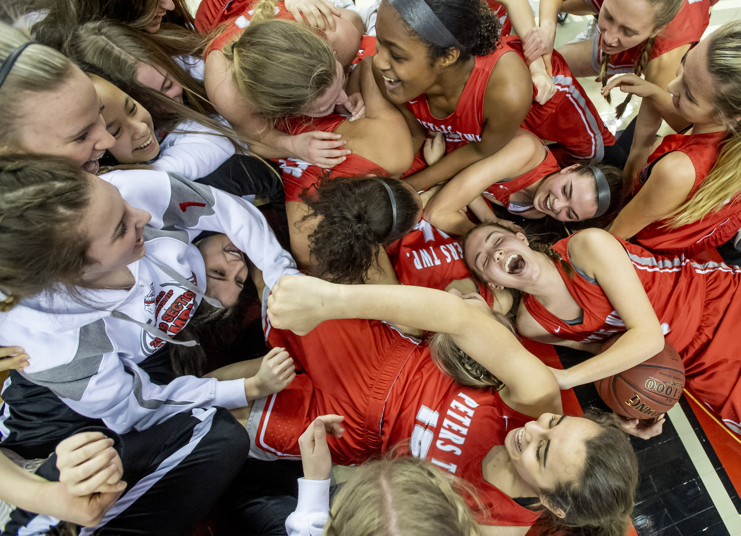  Peters Township players fall to the floor after beating Garnet Valley, 62-49, during the PIAA Class 6A basketball championship on Friday, March 22, 2019, at the Giant Center in Hershey. 