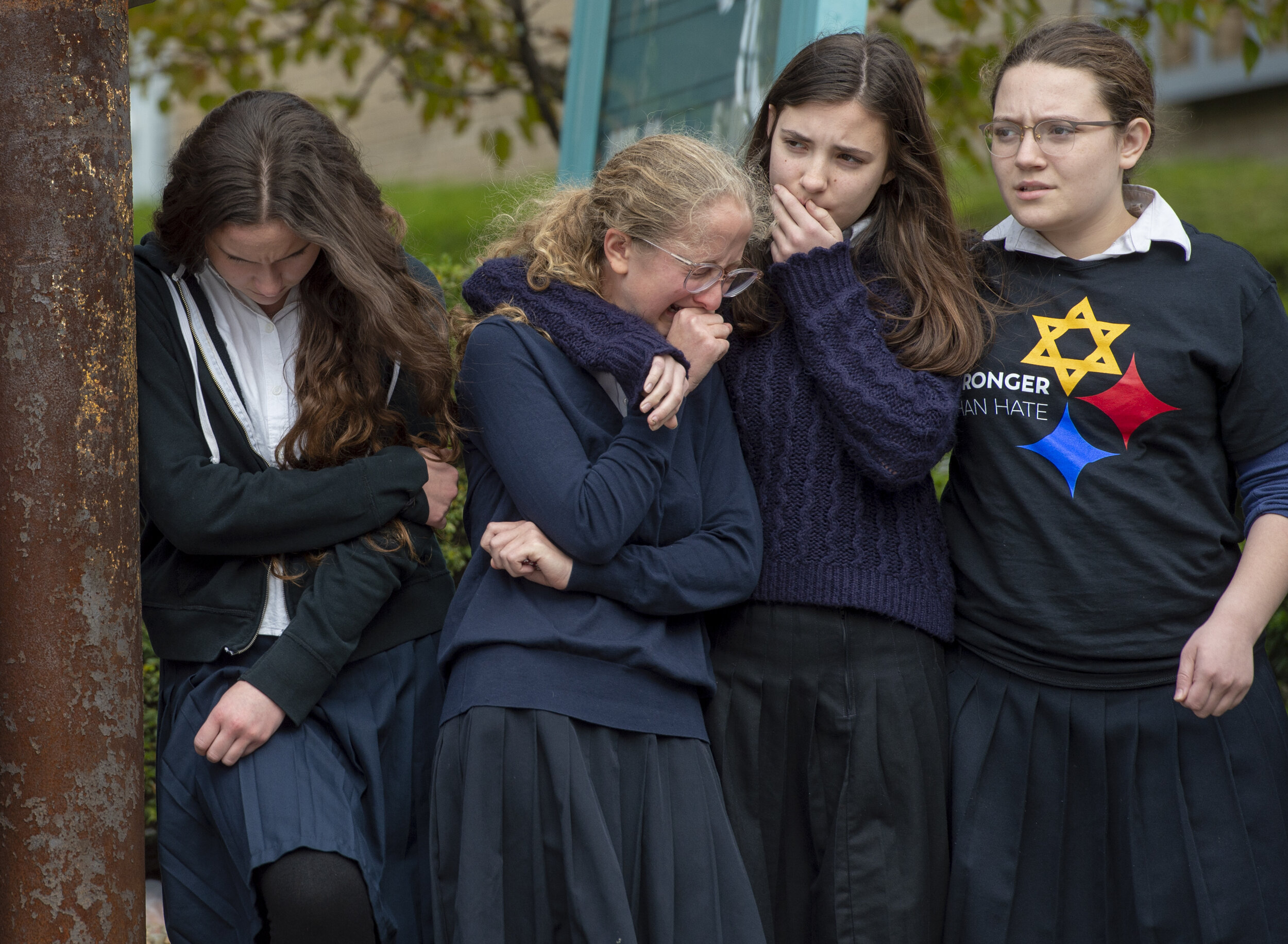  Yeshiva School students Batsheva Ezagui of Florida, Batya Deitsch of Columbus, Ohio, Esther Rivka Shkedi of Squirrel Hill, and Tzipporah Shkedi of Squirrel Hill,  watch a funeral procession for Dr. Jerry Rabinowitz drive along Forbes Avenue as it he