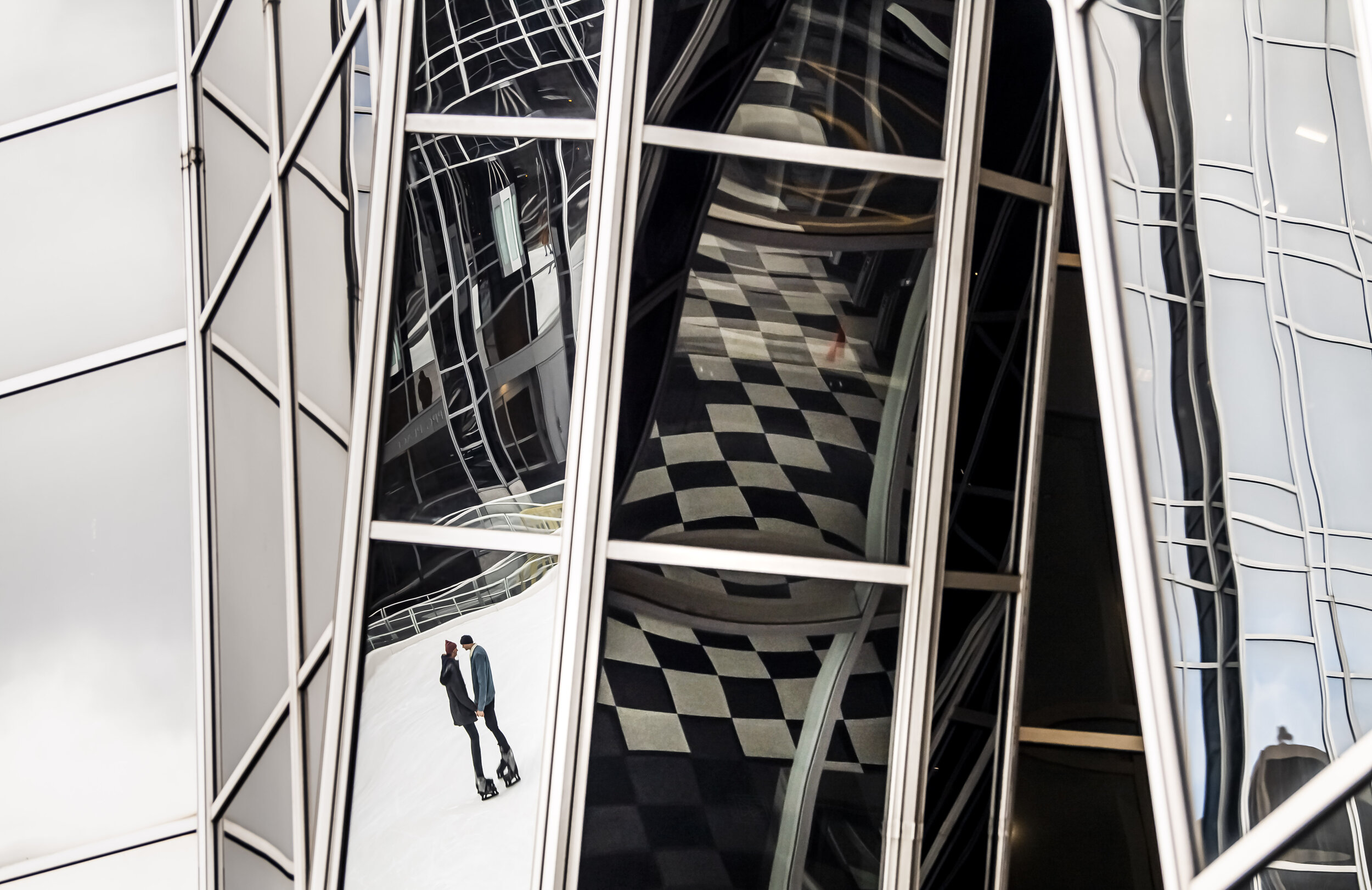  Reflected in PPG Place, Duquesne University students Katie Drennen and Jonny Geisler ice skate on Wednesday, Jan. 8, 2020, at MassMutual Pittsburgh Ice Rink, Downtown. The couple has been dating for eight months.  