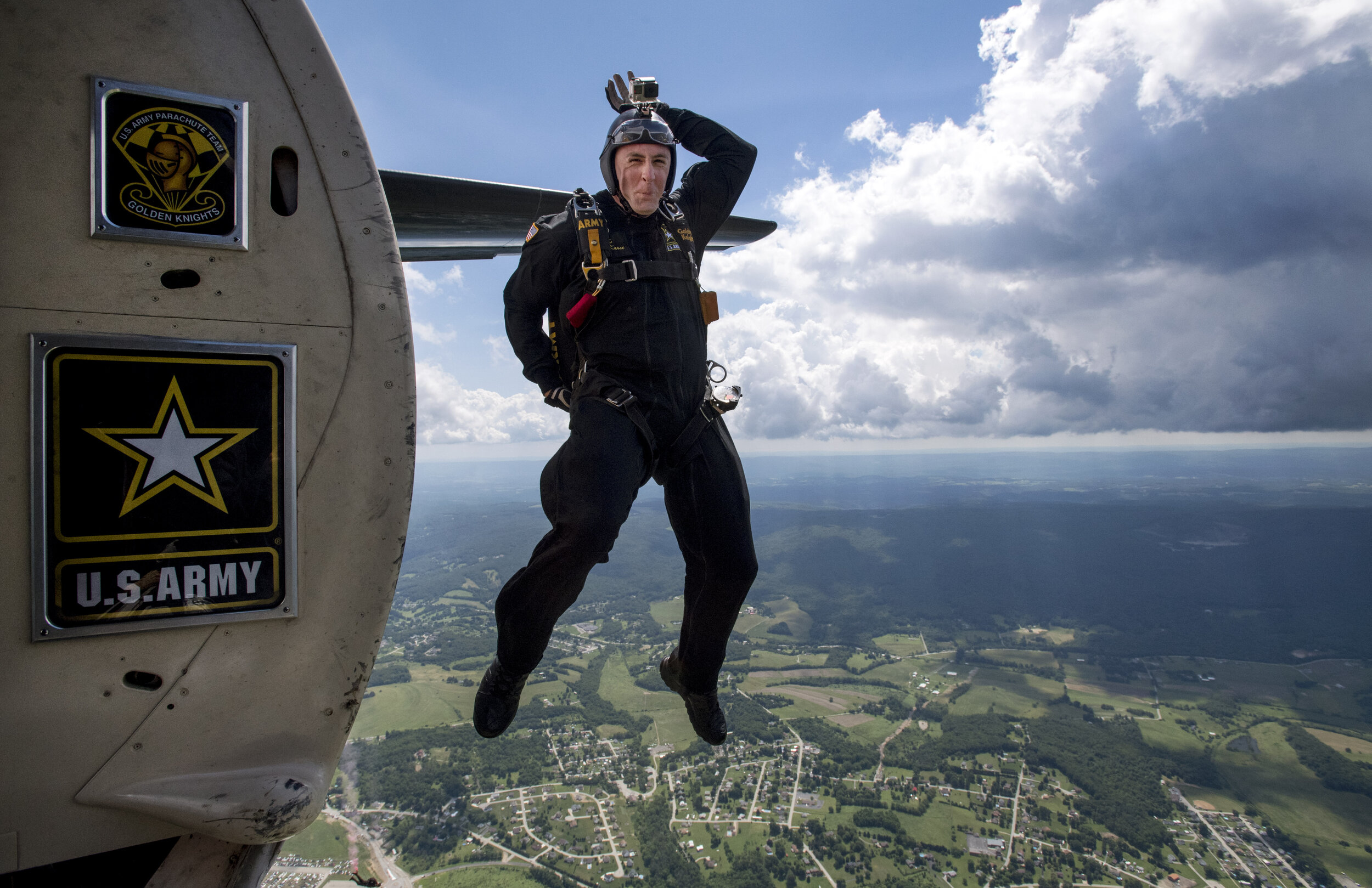  Sgt. 1st Class Brian Karst, of the United States Army Parachute Team Golden Knights and of Vancouver, Washington, protects his head as he leaps out of an airplane during the Shop 'n Save Westmoreland County Airshow on Sunday, June 25, 2017 at Arnold