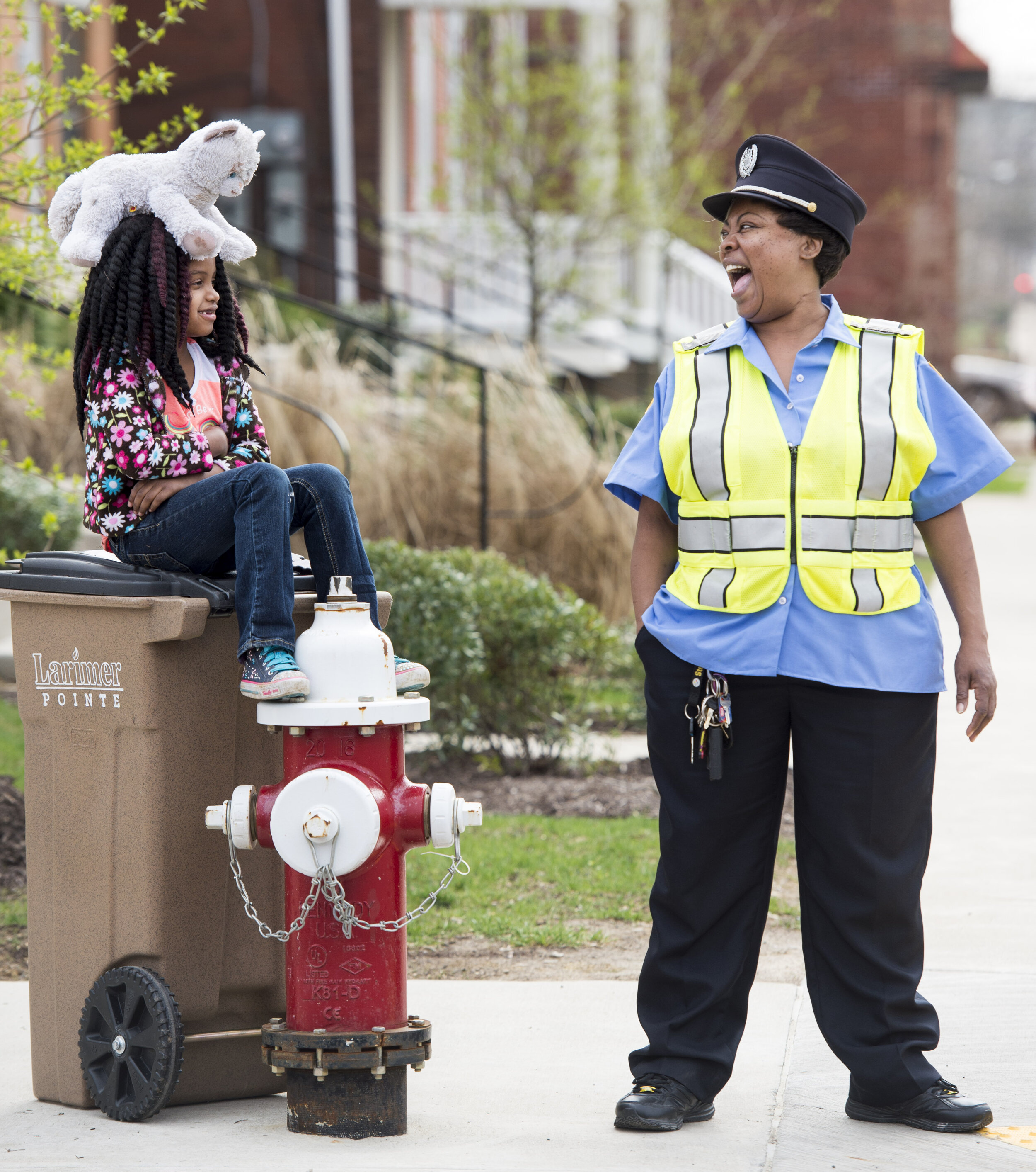  City of Pittsburgh crossing guard Carla Harris (right) laughs with Rhavyn Doubt, 7, and Doubt’s stuffed animal “Fluffy” as Doubt waits with her on Wednesday, April 18, 2018 at the corner of Meadow Street and Larimer Avenue in Larimer. “She’s a sweet