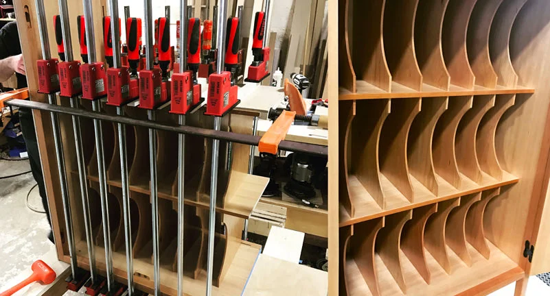 Here you see the the music cabinet's interior vertical partitions that would help Gilda organize her sheet music. On the left you see the partitions clamped in KR+H's shop. When Paul saw this image he smiled and said, "You can never have too many clamps! I've thought that all my life!"