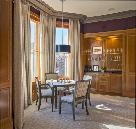 The outside trim at the bay window in the game room required 9-foot-long field miters. The bar area has a sliding pocket door.