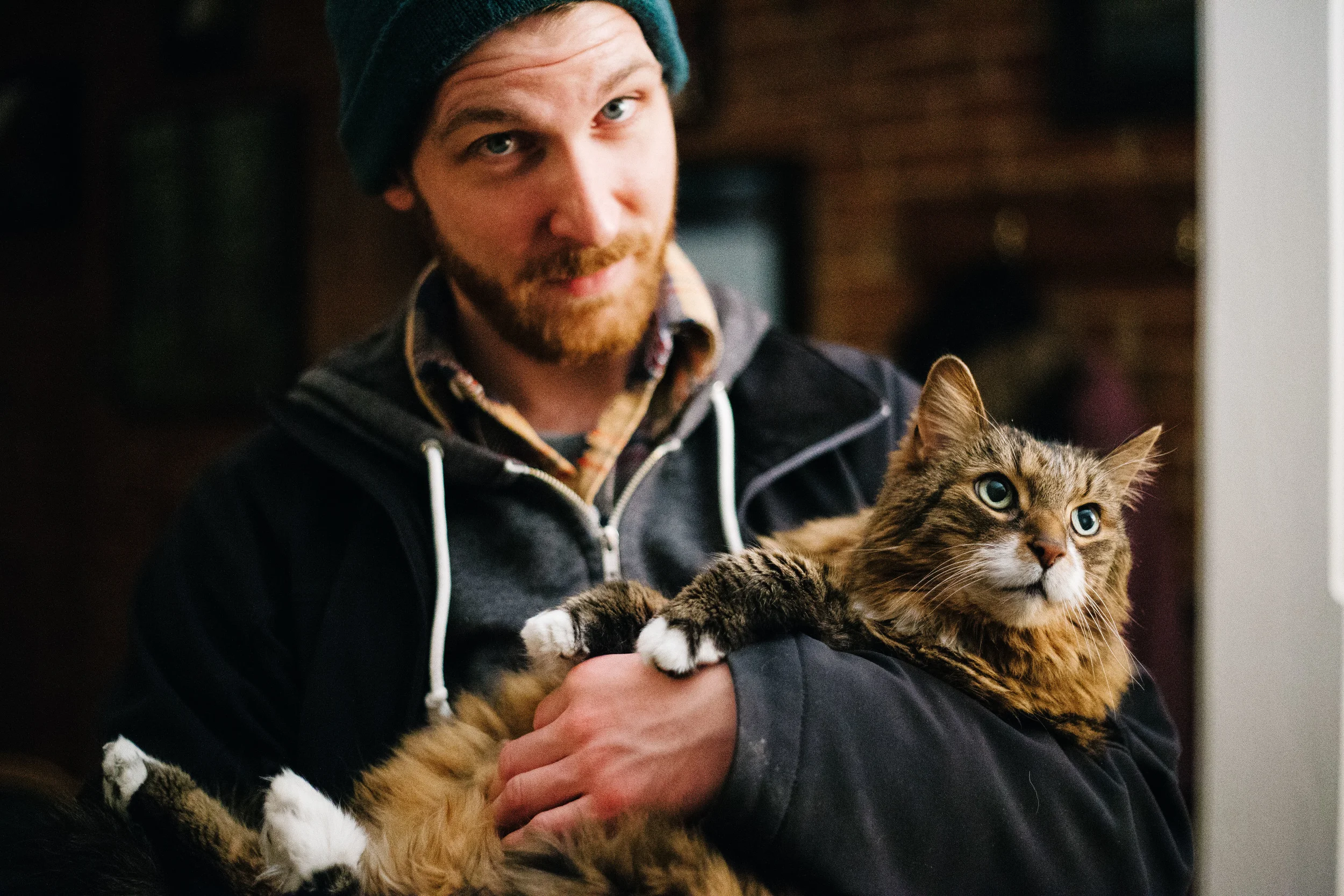 Steve Gibson holds Steve Sladkowski's cat, Brackets at Sladkowski's parents' home in Toronto, Ontario, Wednesday, April 6, 2016.