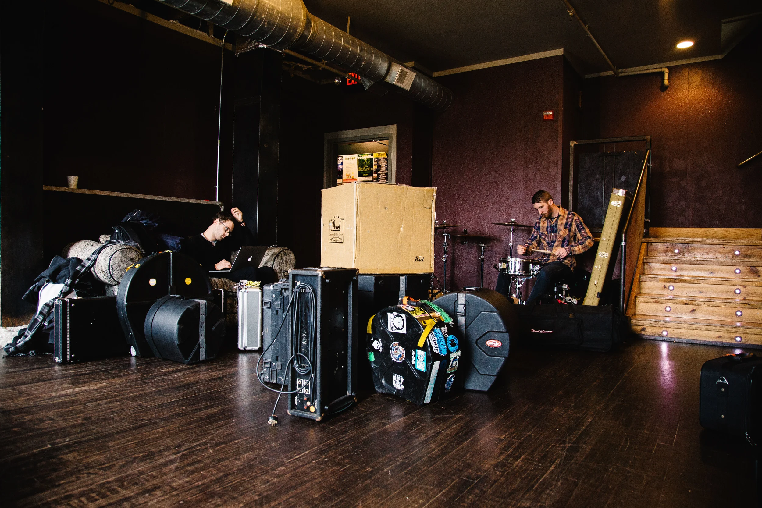 Loren Shumaker works on his computer as Steve Gibson warms up in one of the green rooms at The Crofoot in Pontiac, Michigan, Saturday, April 9 2016.