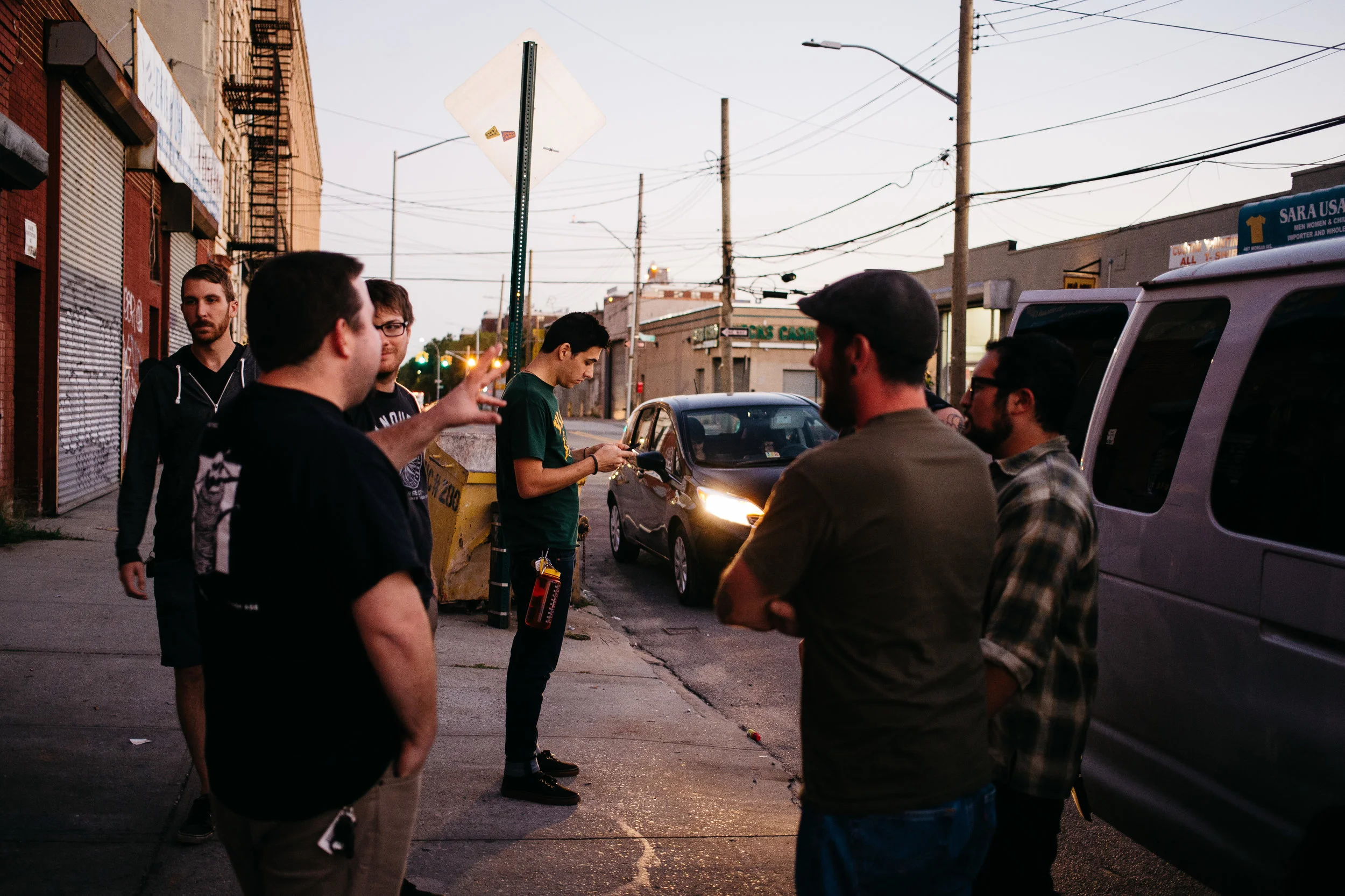 Max on his phone outside of AVIV after the band helped Timeshares with their load in that evening in Brooklyn, New York. 