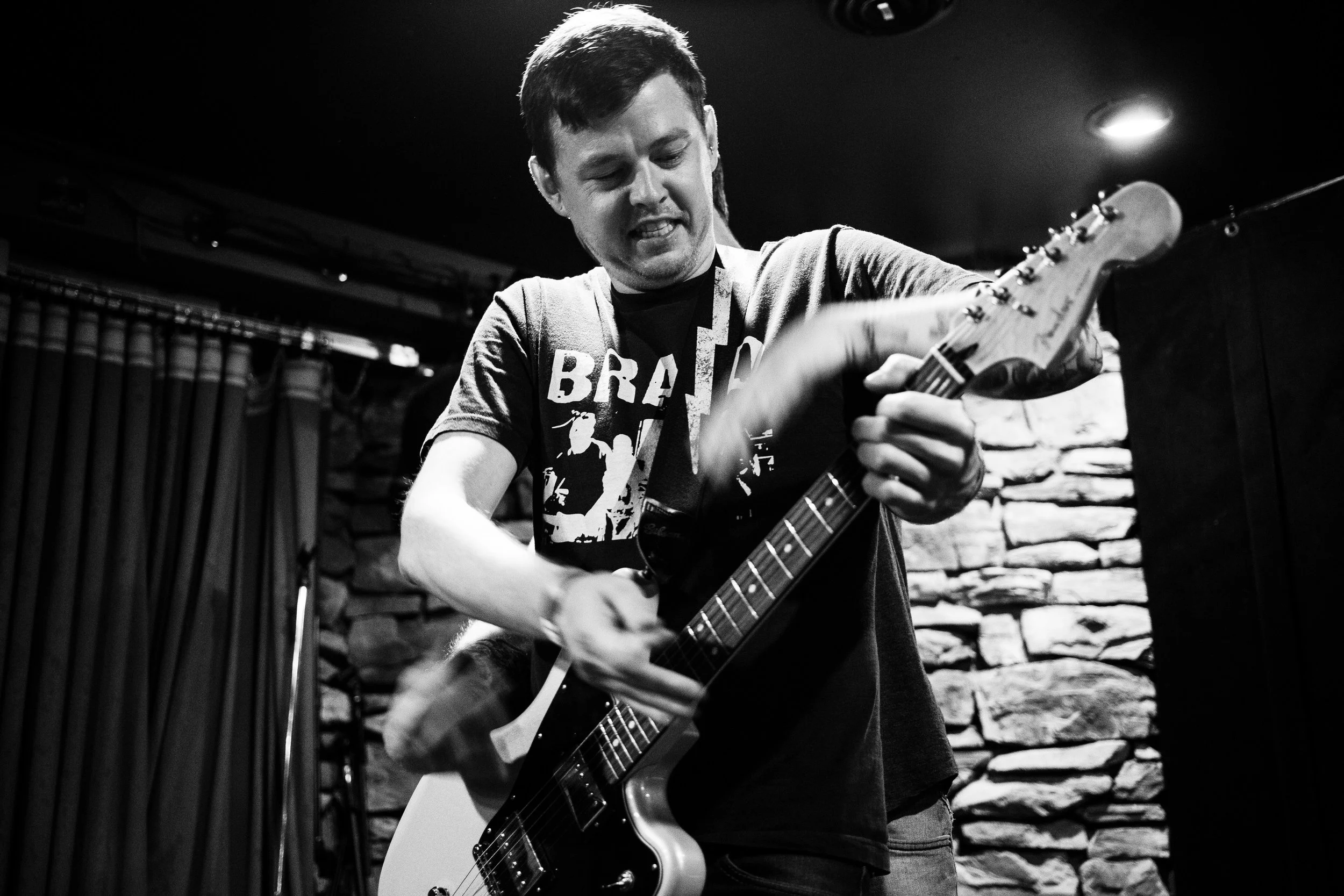 Before sound check, Steve acts as an extra set of hands for Jeff and his guitar playing. 