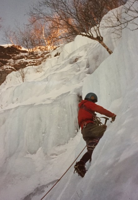 Placing an ice screw. Note: Needed both hands. Hammered in a few inches, then twisting with ice tool.