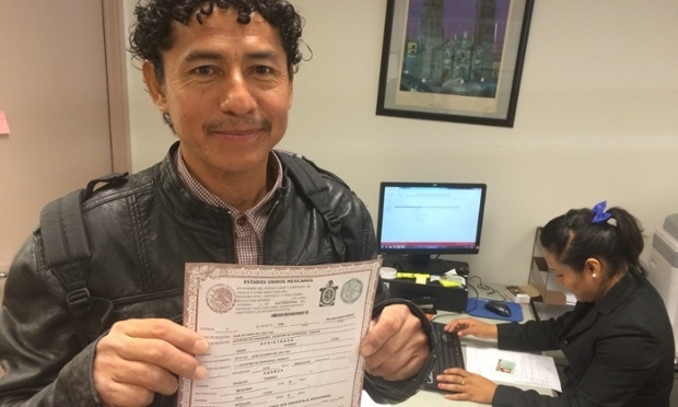 Ángel Ramirez shows his newly printed birth certificate. Photograph: The Guardian