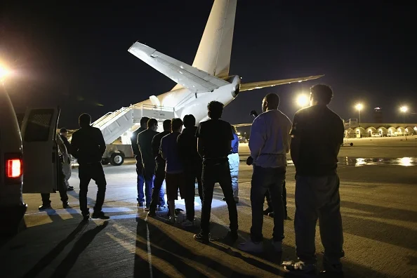 Undocumented immigrants wait to be loaded onto an Immigration and Customs Enforcement (ICE), charter jet early on October 15, 2015 in Mesa, Arizona. The immigrants were to be flown to other states for follow-on ICE deportation flights to the Caribbean, Mexico and Central America. ICE builds deportation cases against thousands of undocumented immigrants, many of whom, they say, have criminal records. The number of ICE detentions and deportations has dropped in the last two years since some states adopted laws limiting how state law enforcement agencies cooperate with federal immigration authorities. (Photo : John Moore/Getty Images)