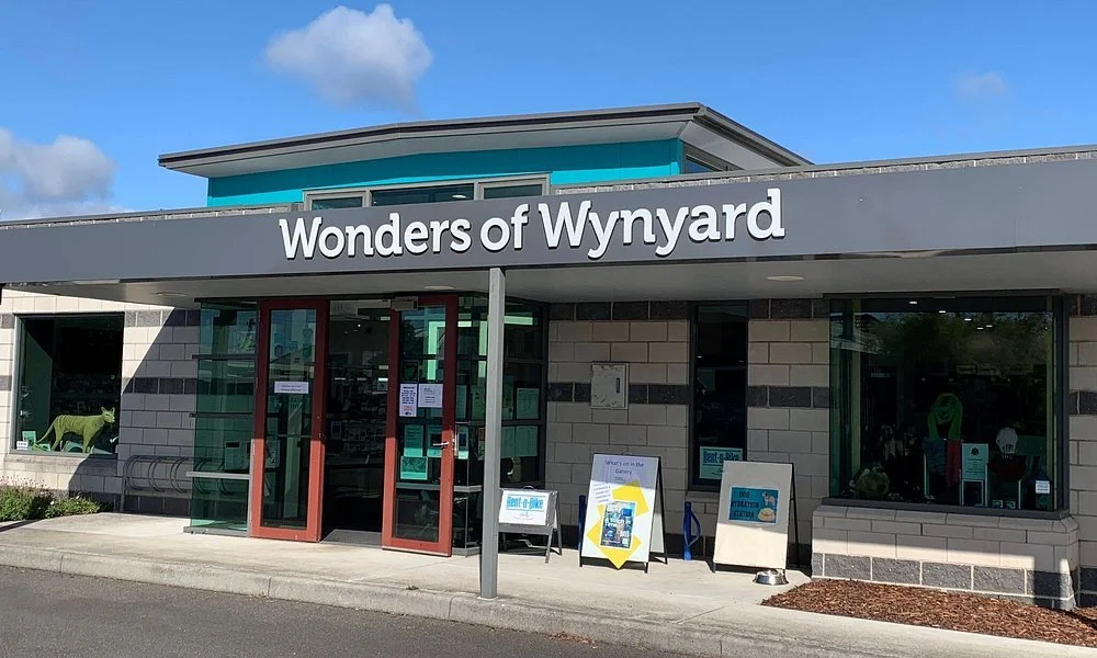 The storefront of Wonders of Wynyard, a retail store with glass doors and windows, outdoor signs, and a sign displaying the store's name.