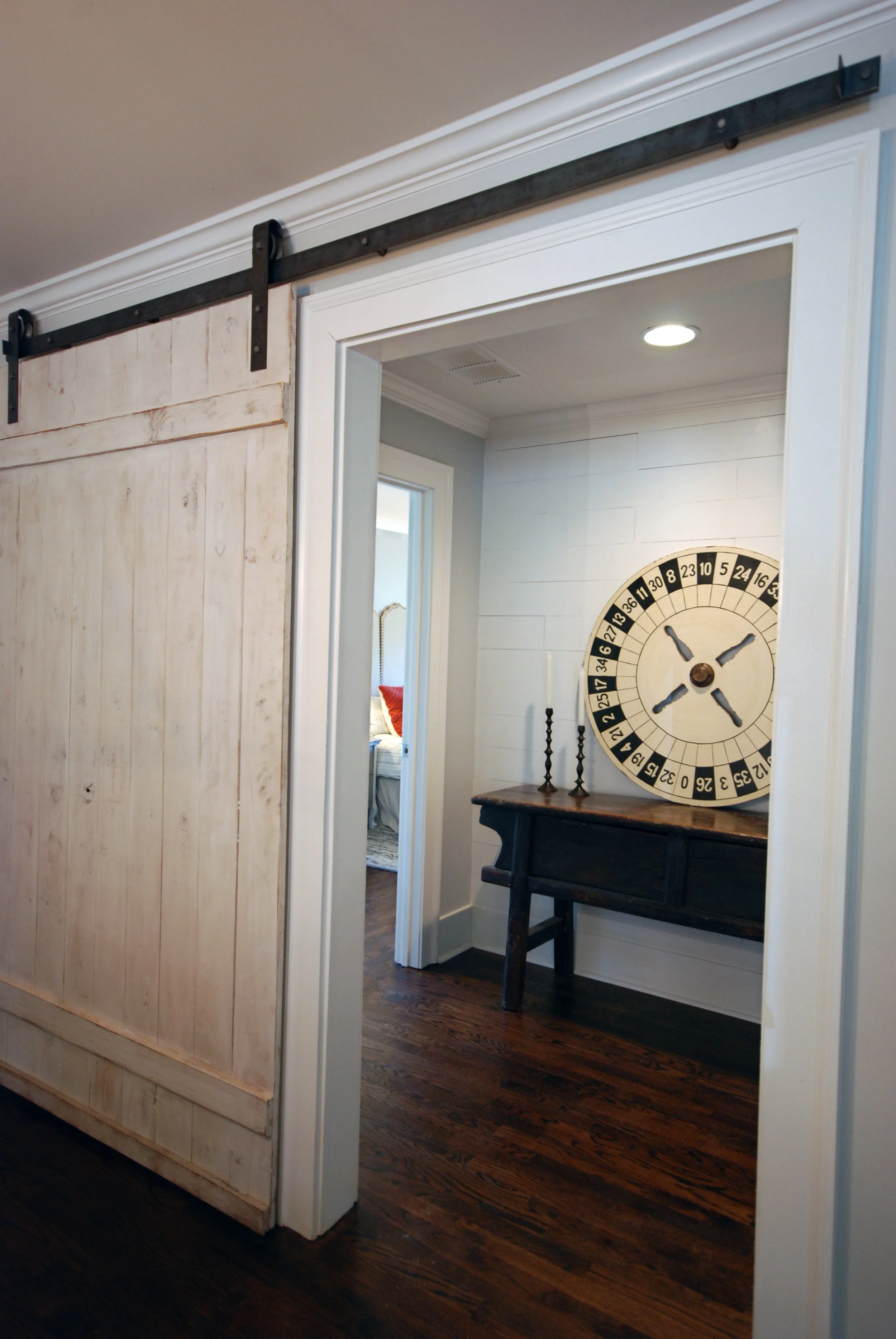 Custom touches such as barn doors and plank walls make this house feel like a home.