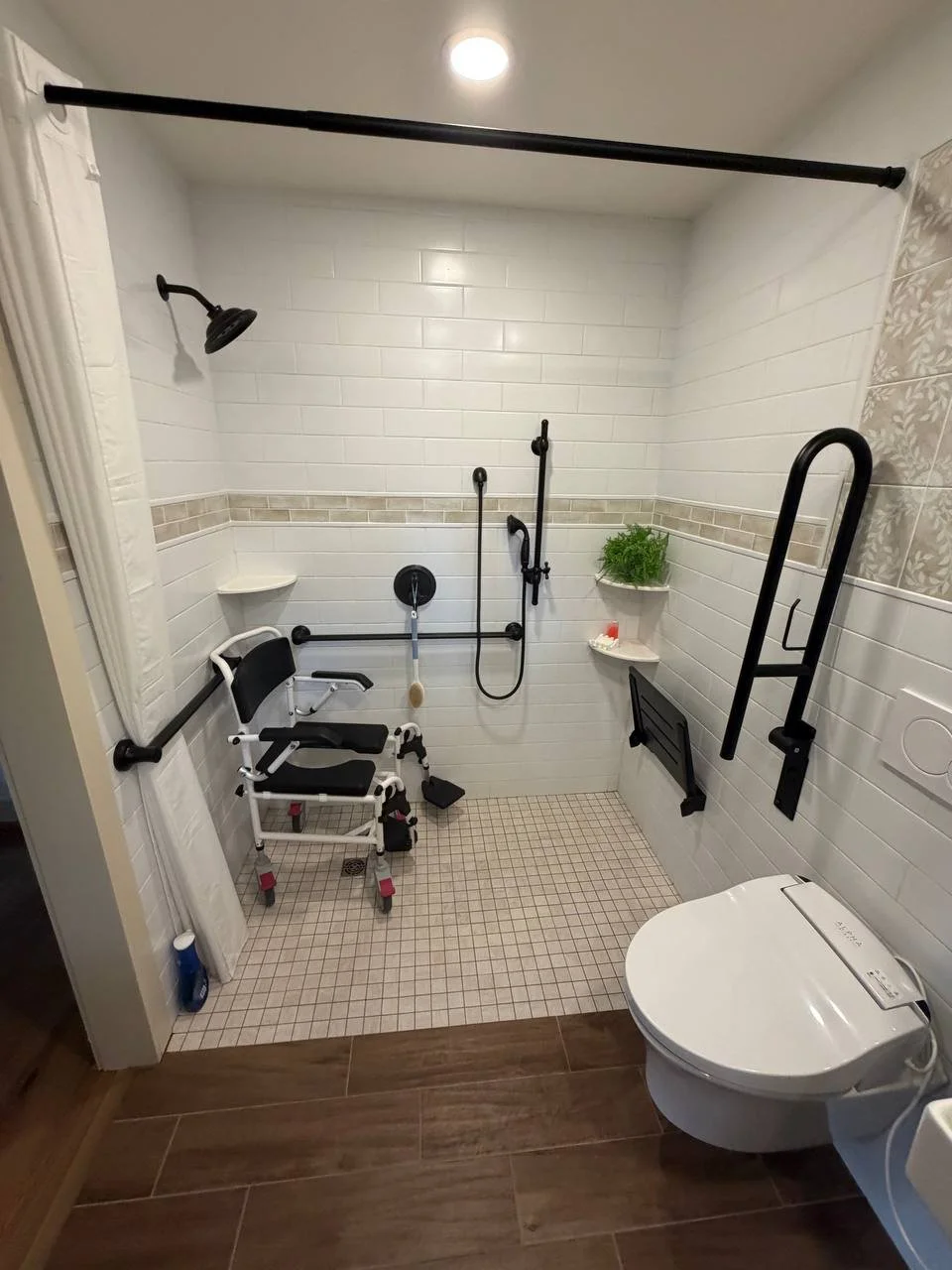 “Custom roll-in shower designed by BFA, LLC with barrier-free entry, personalized grab bar placement, and seat height tailored to the homeowner’s mobility needs.”