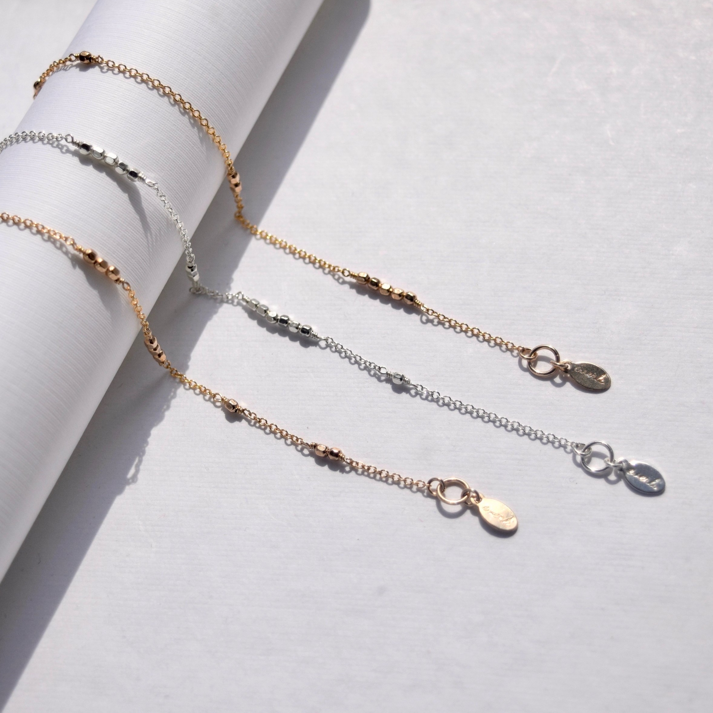 A subtle Morse code bracelet that lets you encode your secret name or word. Featuring shimmering dots and chain dashes, it's a barely there secret for you to keep close every day.