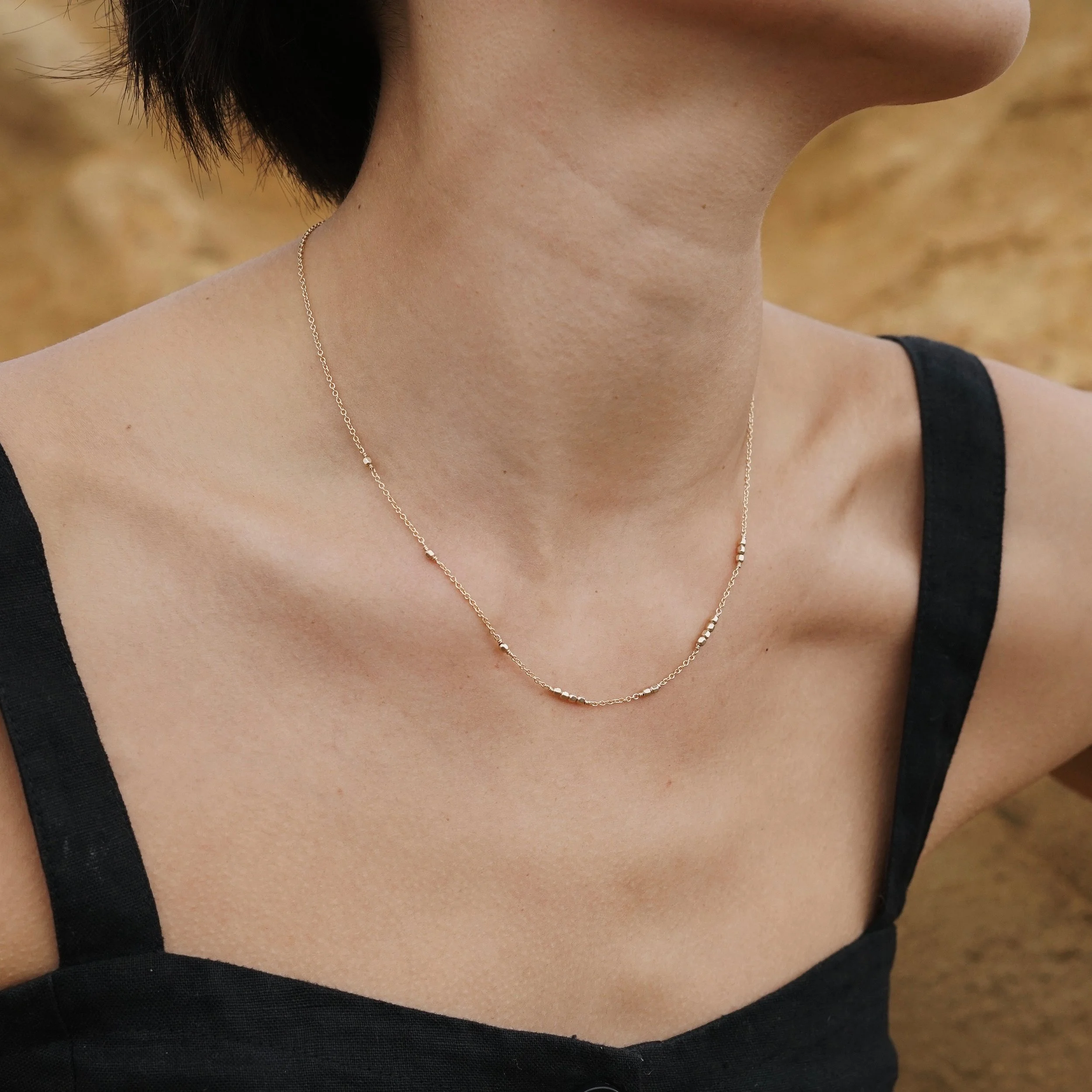 A subtle Morse code necklace that lets you encode your secret name, word or message. Featuring hand-strung dots and chain dashes, it’s versatile to style and ultra layerable.