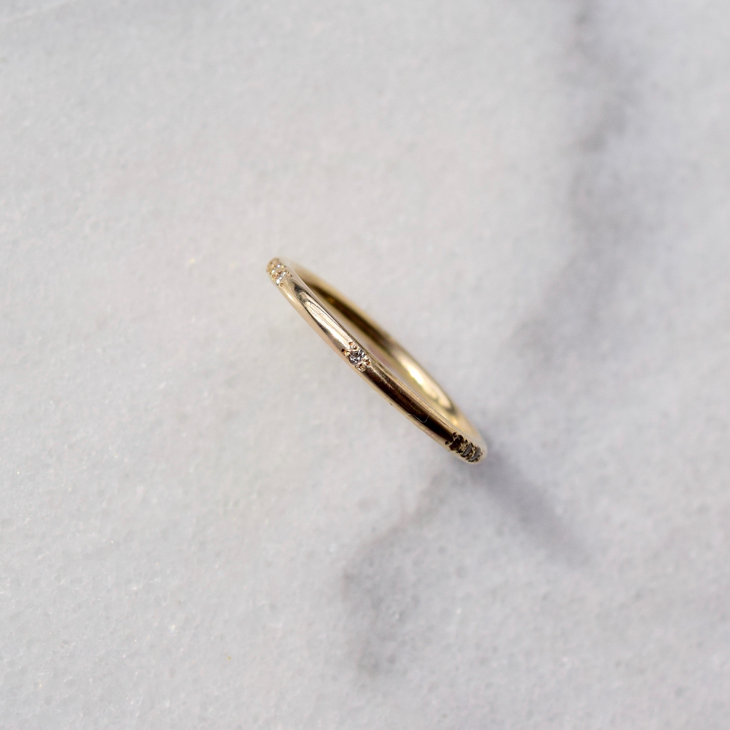 A subtle Morse Code ring disguised as a gold diamond band. The sparkling diamonds and spaces in between together spell out whatever it is that stirs your heart. What will yours say?