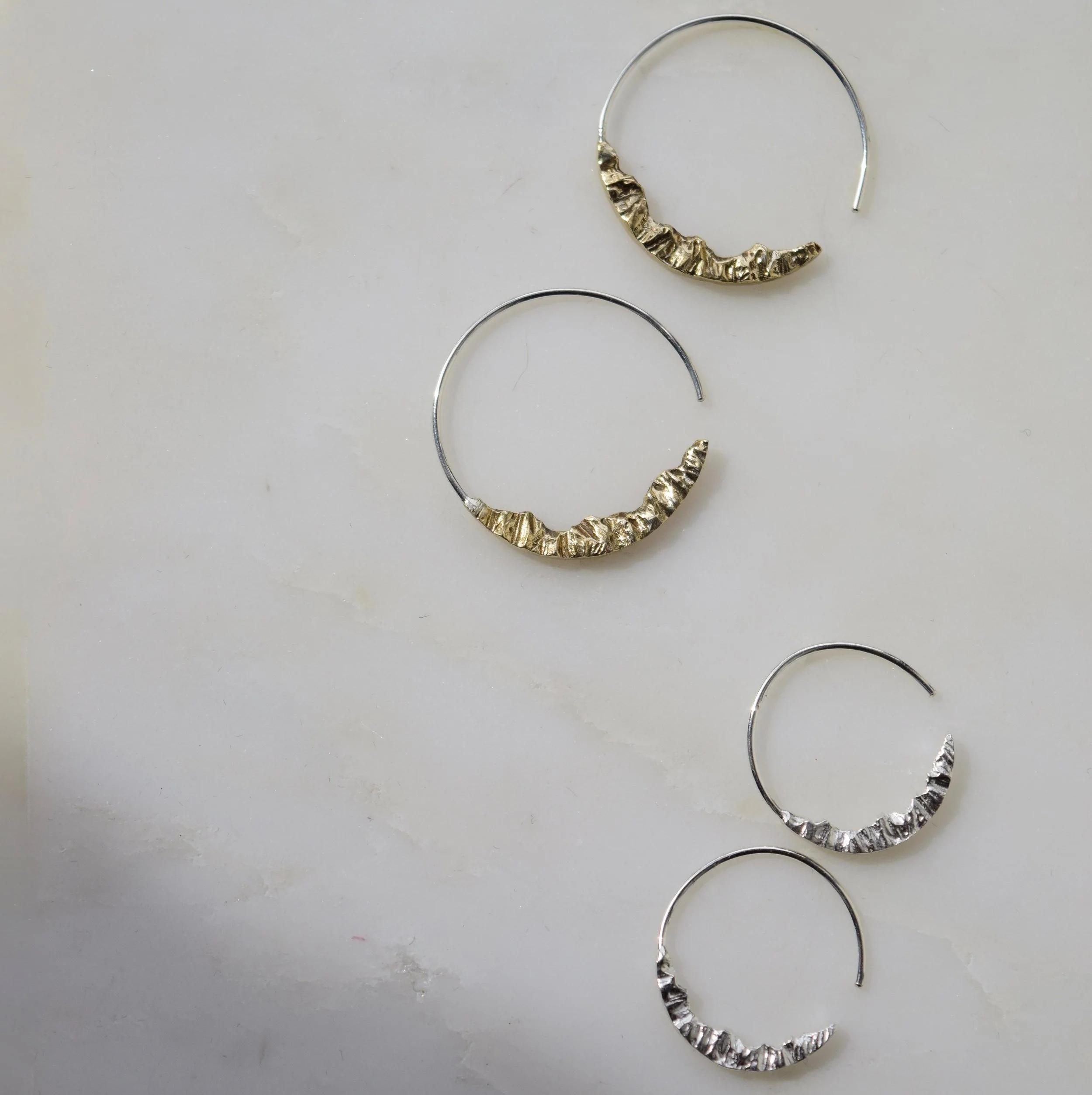 Lightweight mountain hoop earrings with unique detailing of a mountain range. Wear them to stay connected to the adventurous spirit in you. See more mountain jewelry at www.everlijewelry.com