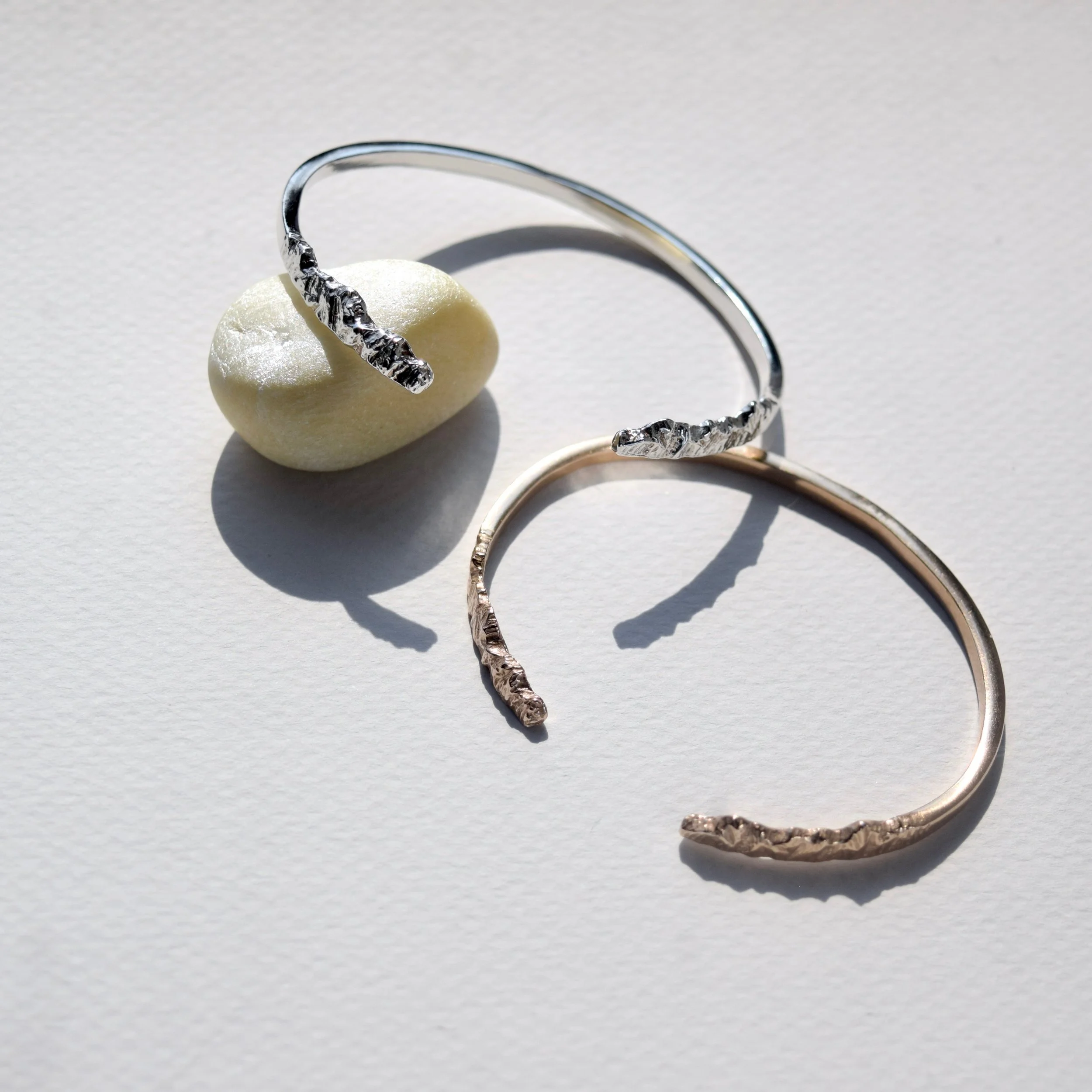 A sleek mountain bracelet cuff that ends with textured peaks and valleys. Wear it as a reminder to enjoy every step of your journey. View our mountain jewelry at www.everlijewelry.com/mountains