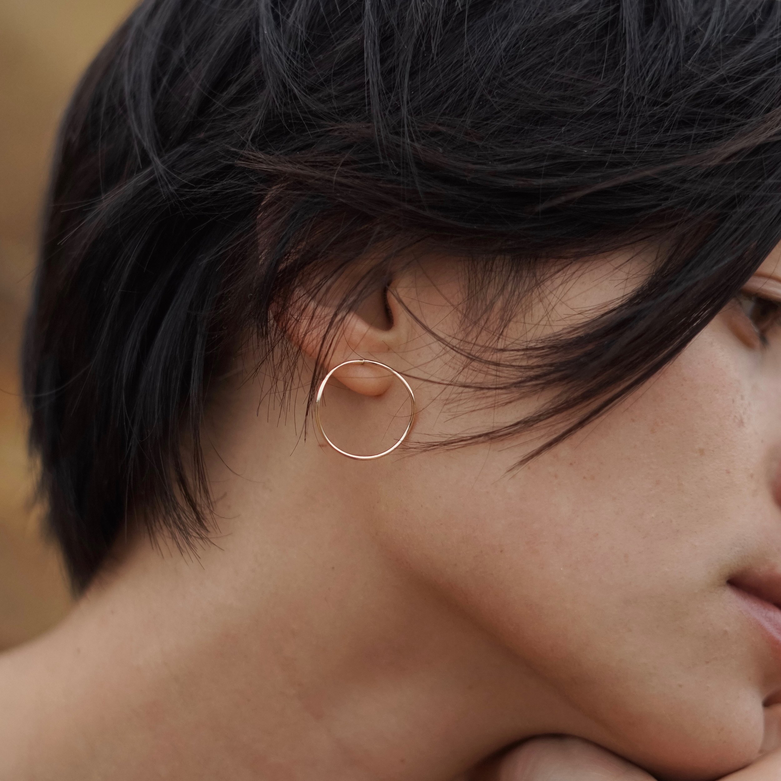 These wave inspired earrings give the classic hoops a modern twist. Simple yet dynamic, a reminder of change as life's constant and the freedom we can gift ourselves when we learn to go with the flow.