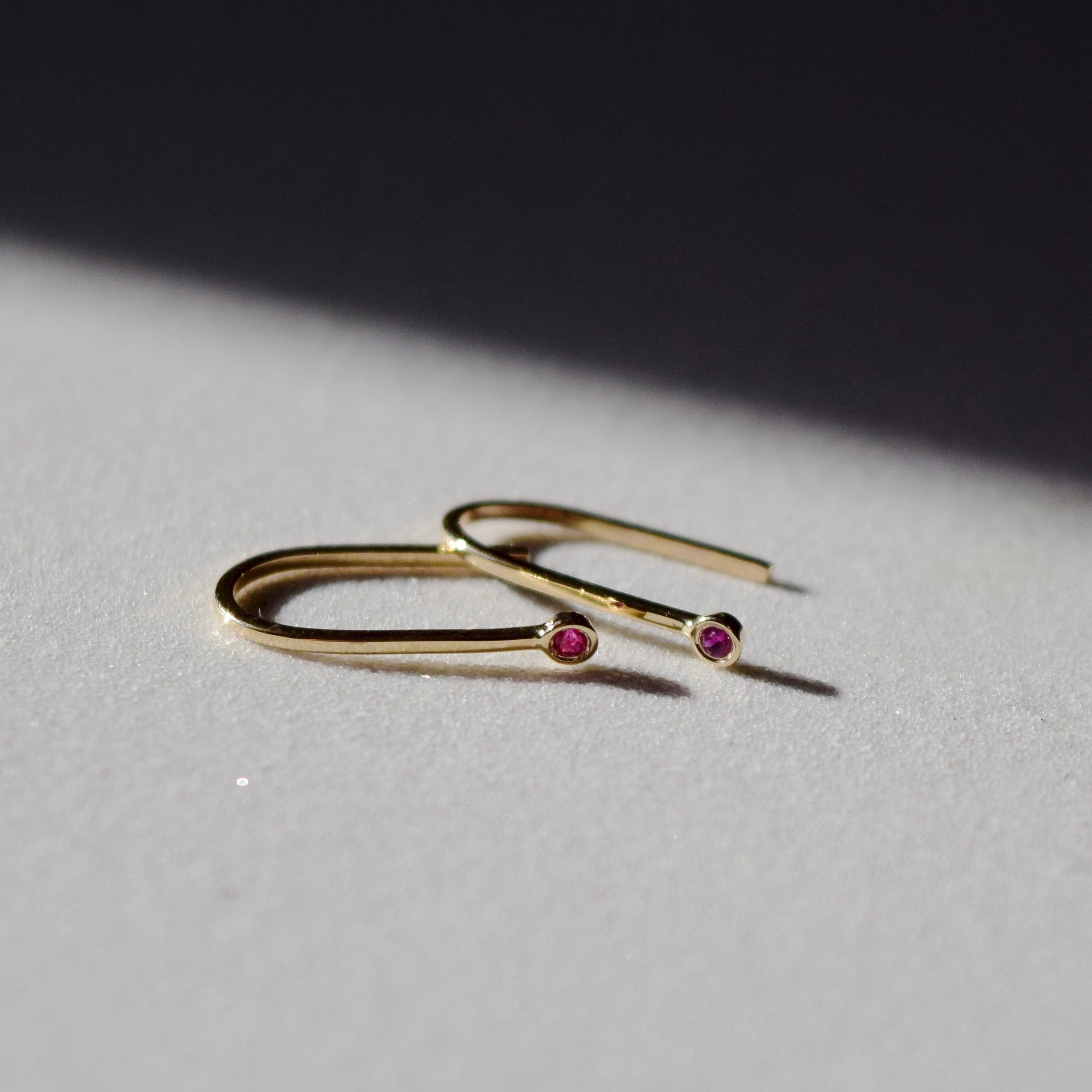 Simple gold ruby earrings, shaped like little magnets. A reminder to be the energy that we want to attract.