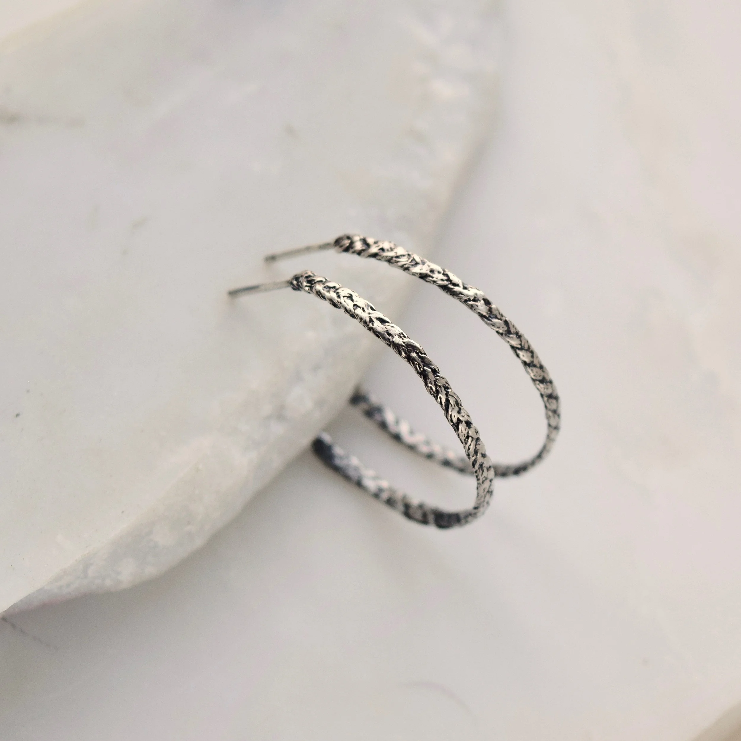 Playful braided hoops cast from woven threads, in honor of the colorful friendship bracelets you made as a kid. A fun reminder of carefree summers and time spent with your besties.