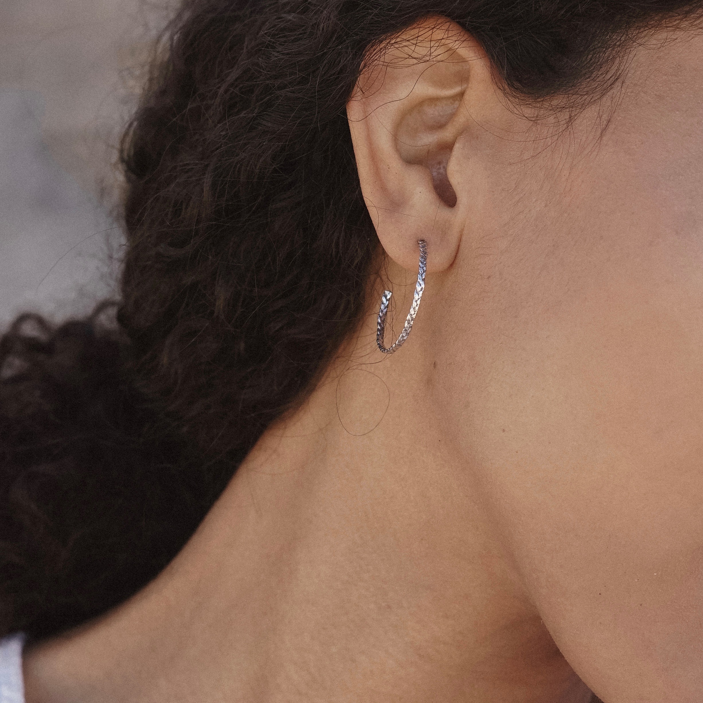 Playful braided hoops cast from woven threads, in honor of the colorful friendship bracelets you made as a kid. A fun reminder of carefree summers and time spent with your besties.