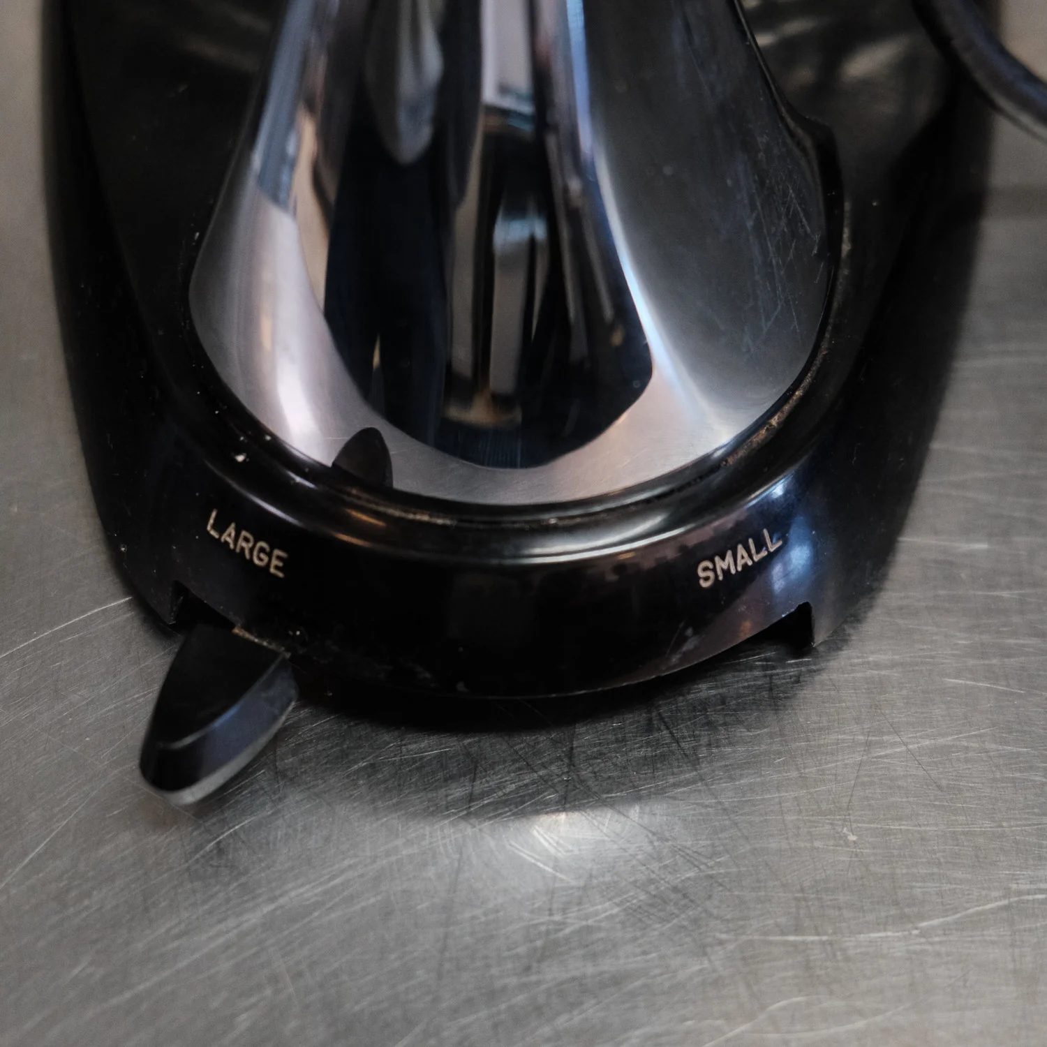 The lever at the base to change bowl sizes