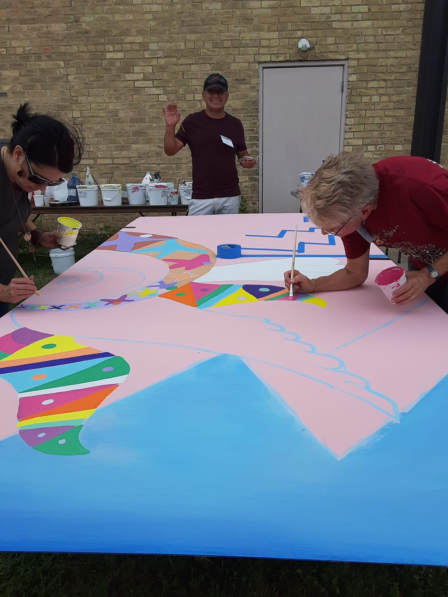  Victor Yepez and visitors painting mural 