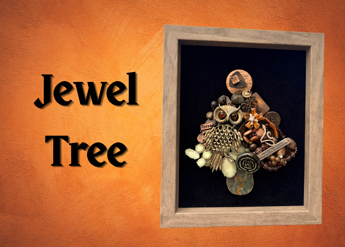 Image of jewelry arranged into the shape of a tree attached to a frame